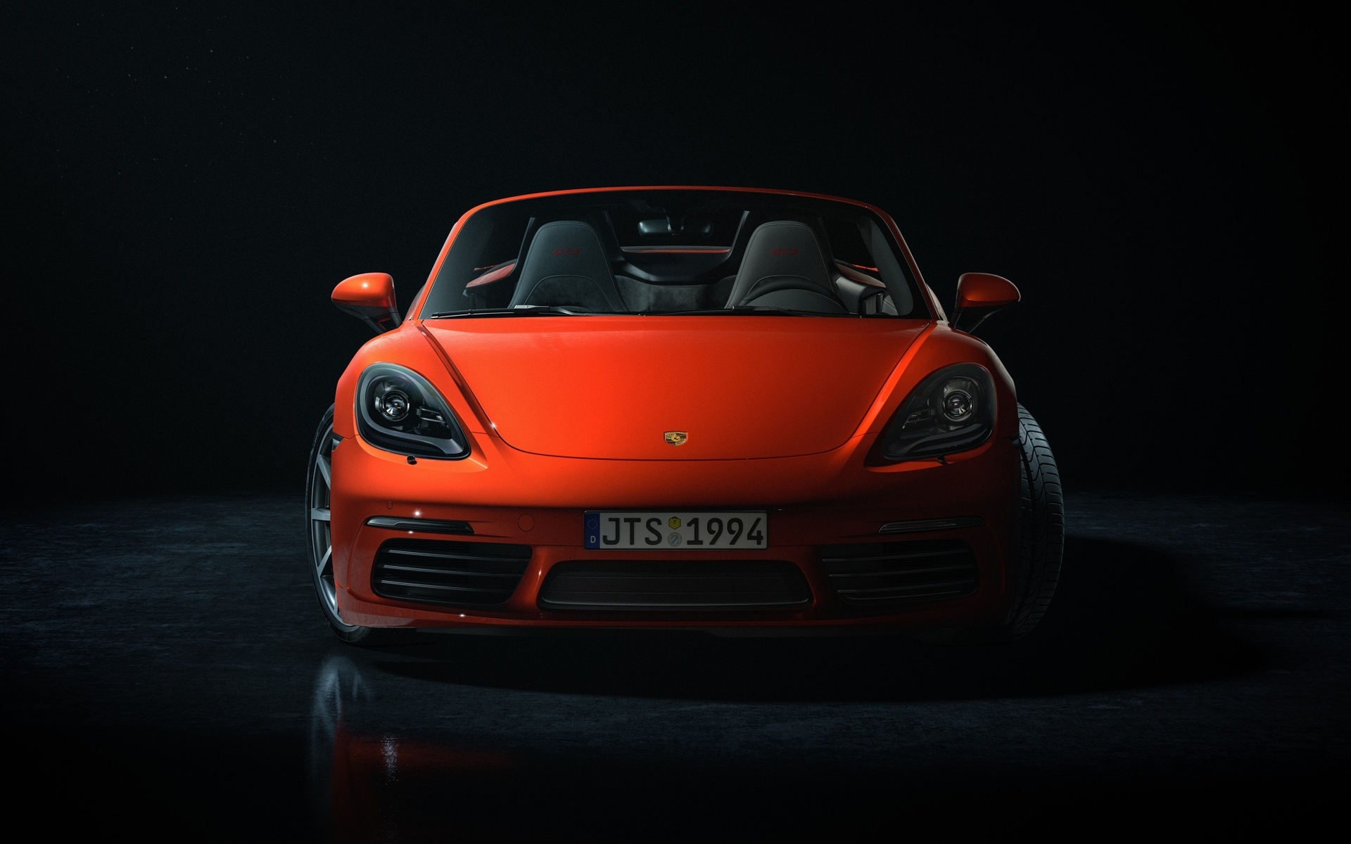 Красный автомобиль Porsche 911 CGI  вид спереди на черном фоне