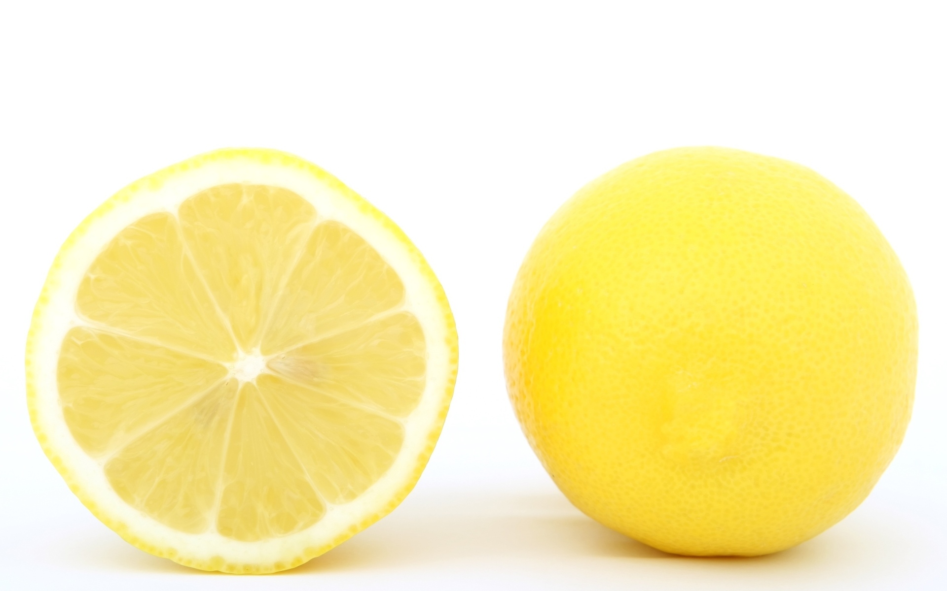 Большой желтый спелый лимон на белом фоне