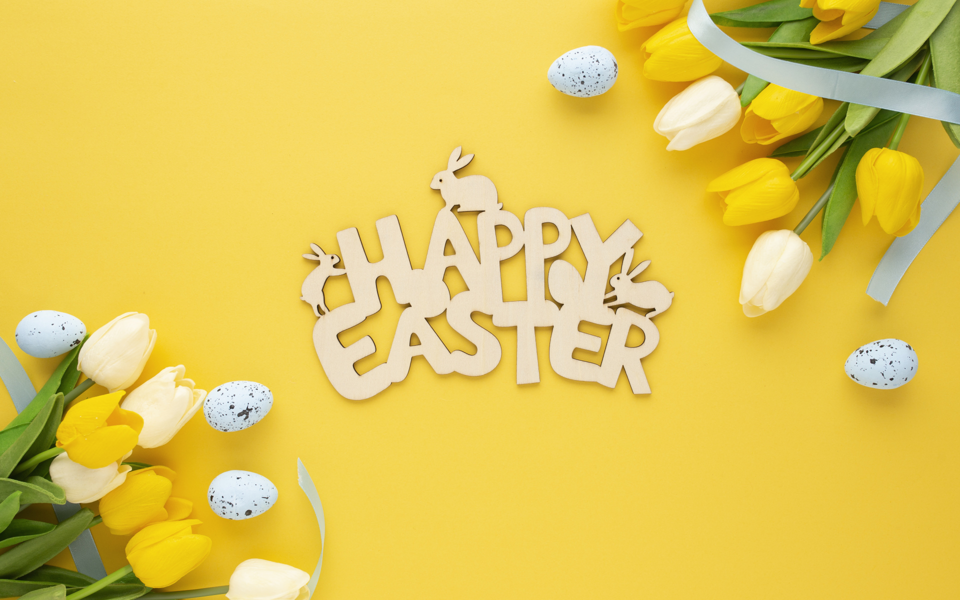 Надпись Счастливой Пасхи на желтом фоне с тюльпанами