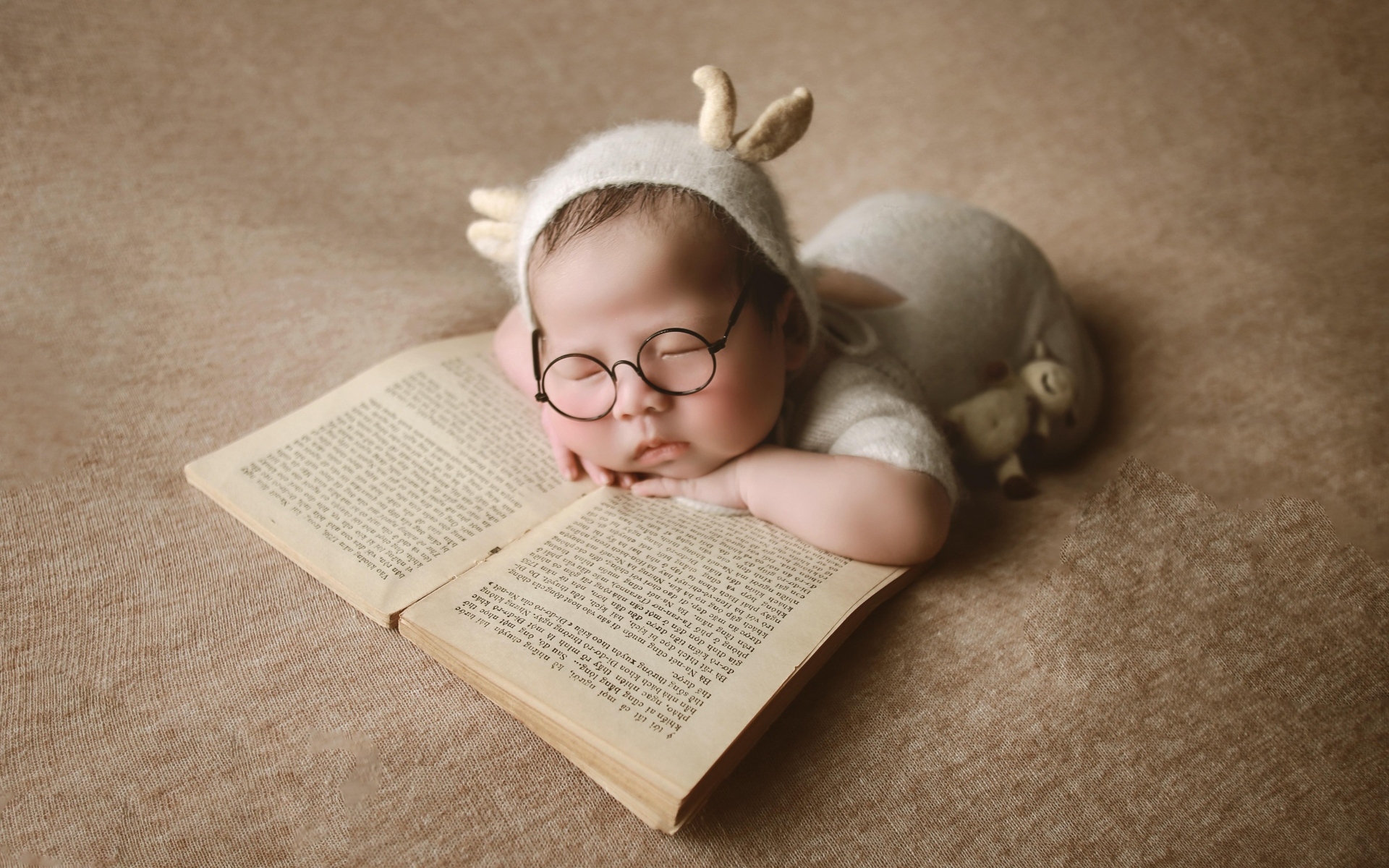 Новорожденный ребенок спит с книгой