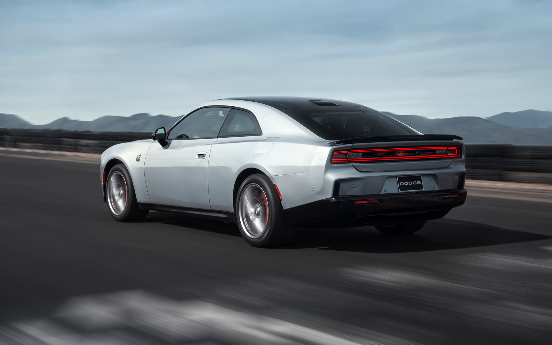 Серебристый автомобиль Dodge Charger Daytona Scat Pack 2024 года на дороге