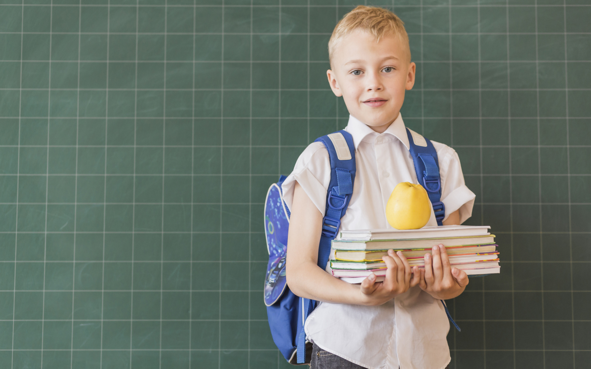 Мальчик школьник с книгами у доски