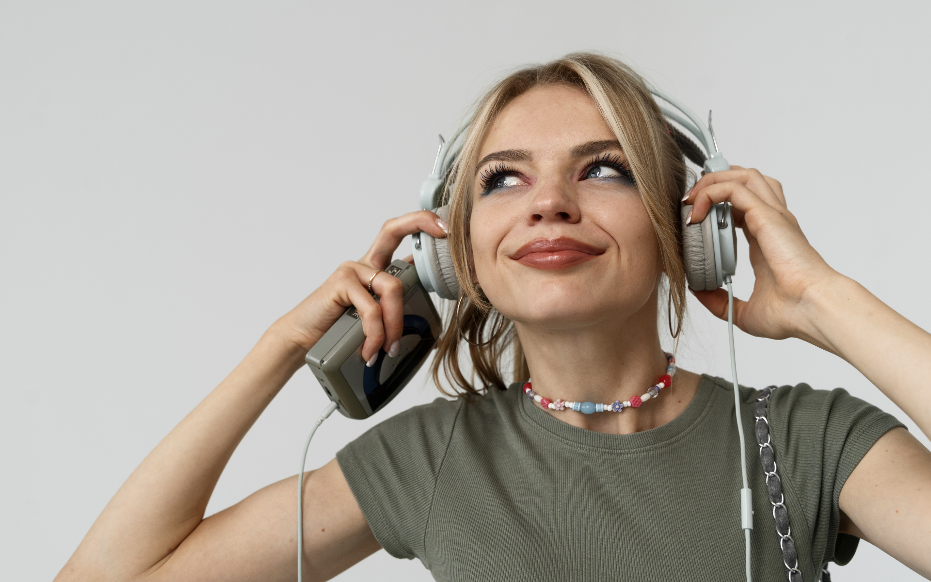 Красивая девушка в наушниках с плеером