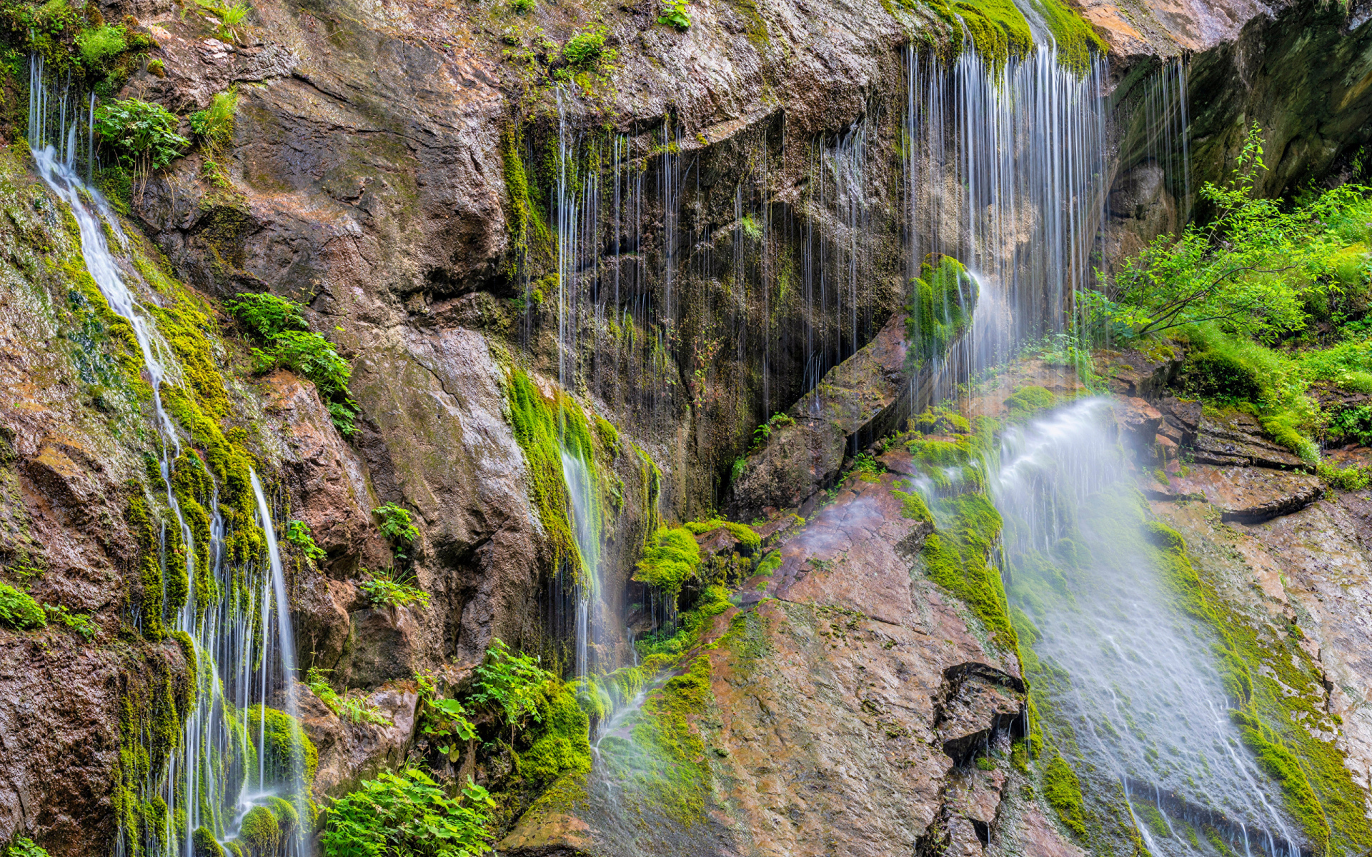 Водопад стекает по большим холодным камнях