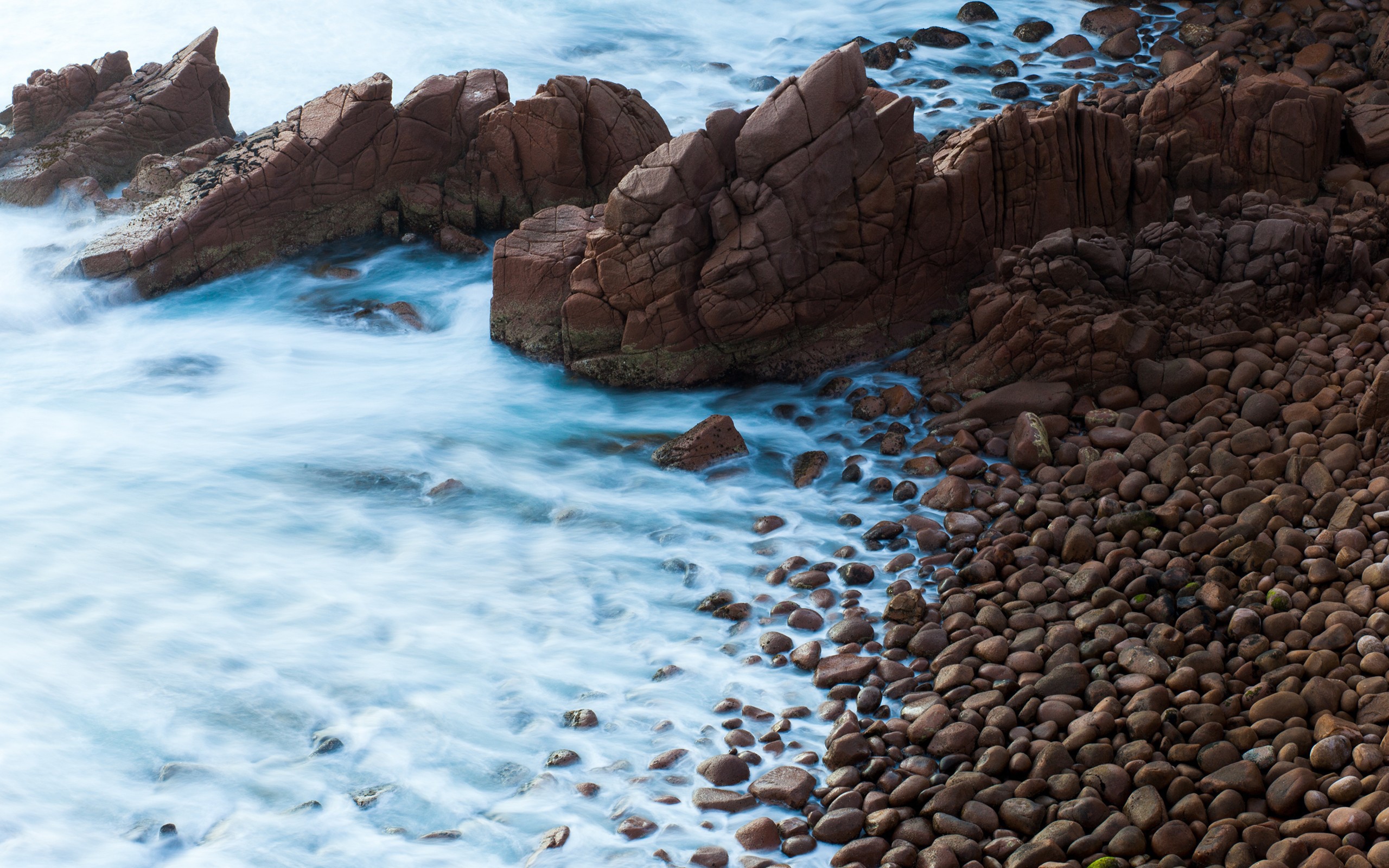 Мелкие коричневые камни на берегу моря