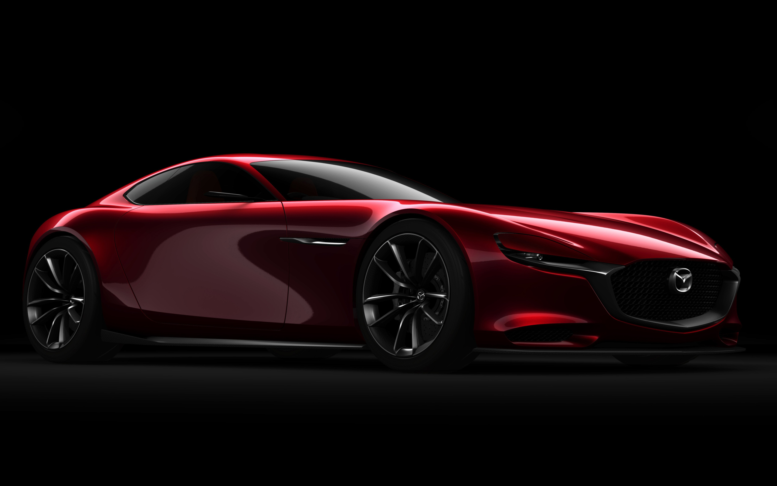 Красный спортивный автомобиль Mazda RX Vision Concept на черном фоне