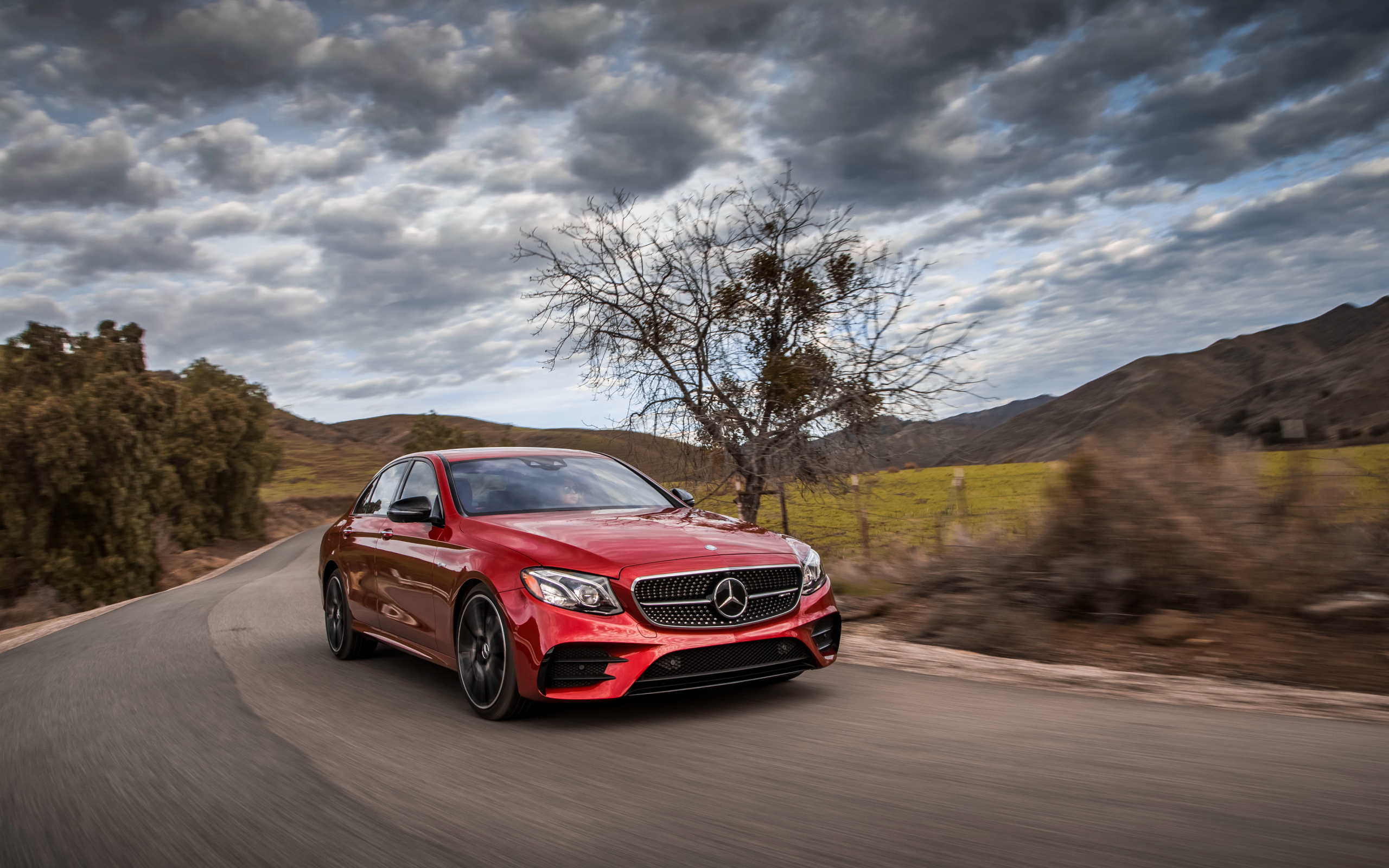 Stylish red Mercedes-Benz E-Class on the sky
