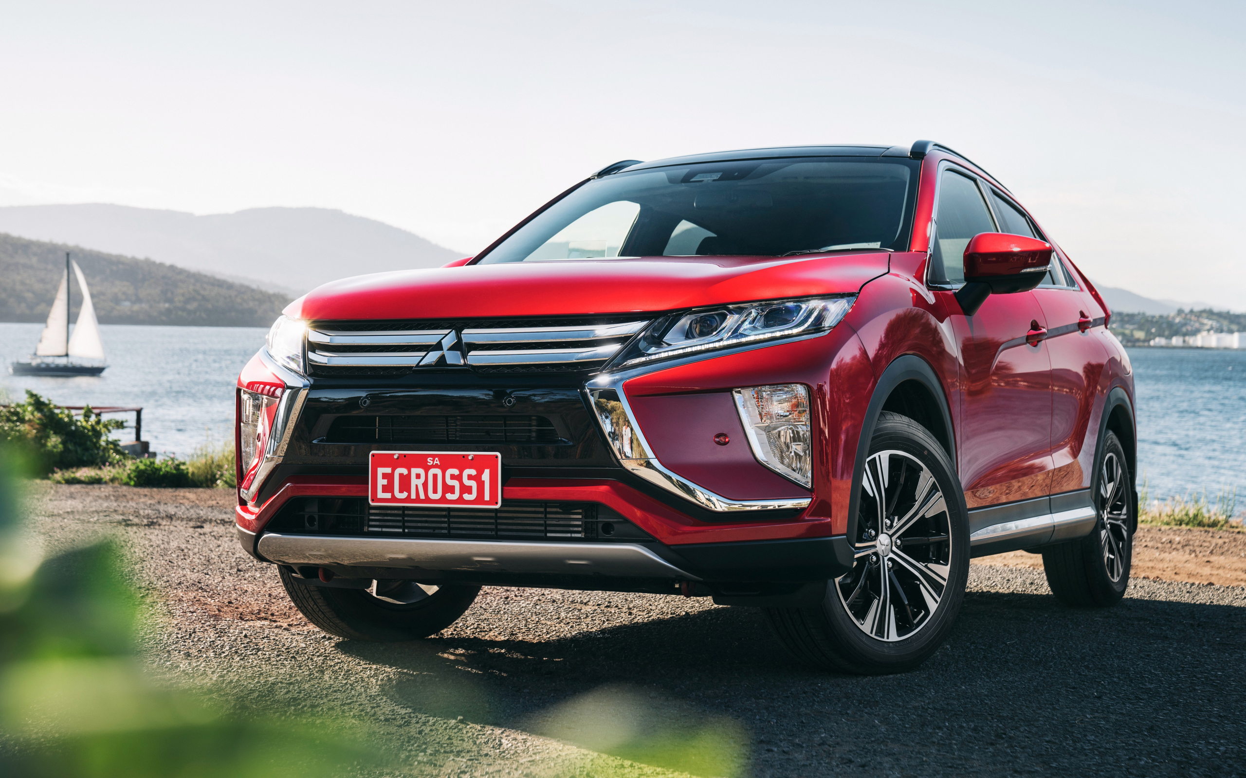 Red SUV Mitsubishi Eclipse Cross Exceed, 2018 on the background of the ocean