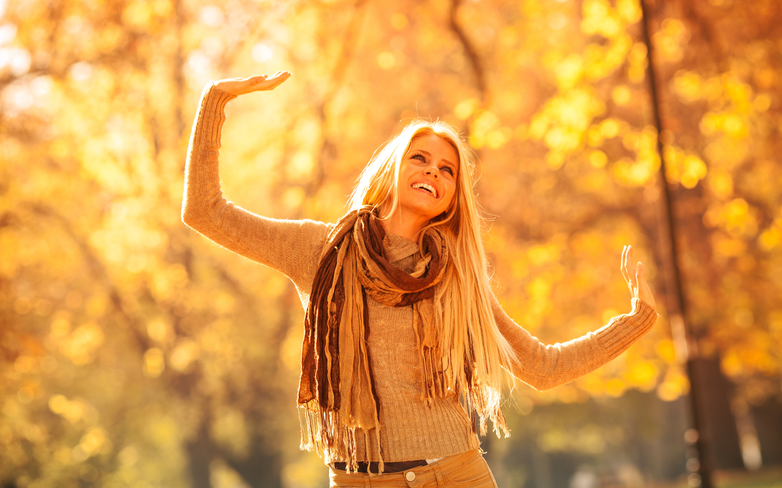 Молодая красивая девушка радуется теплому осеннему солнцу