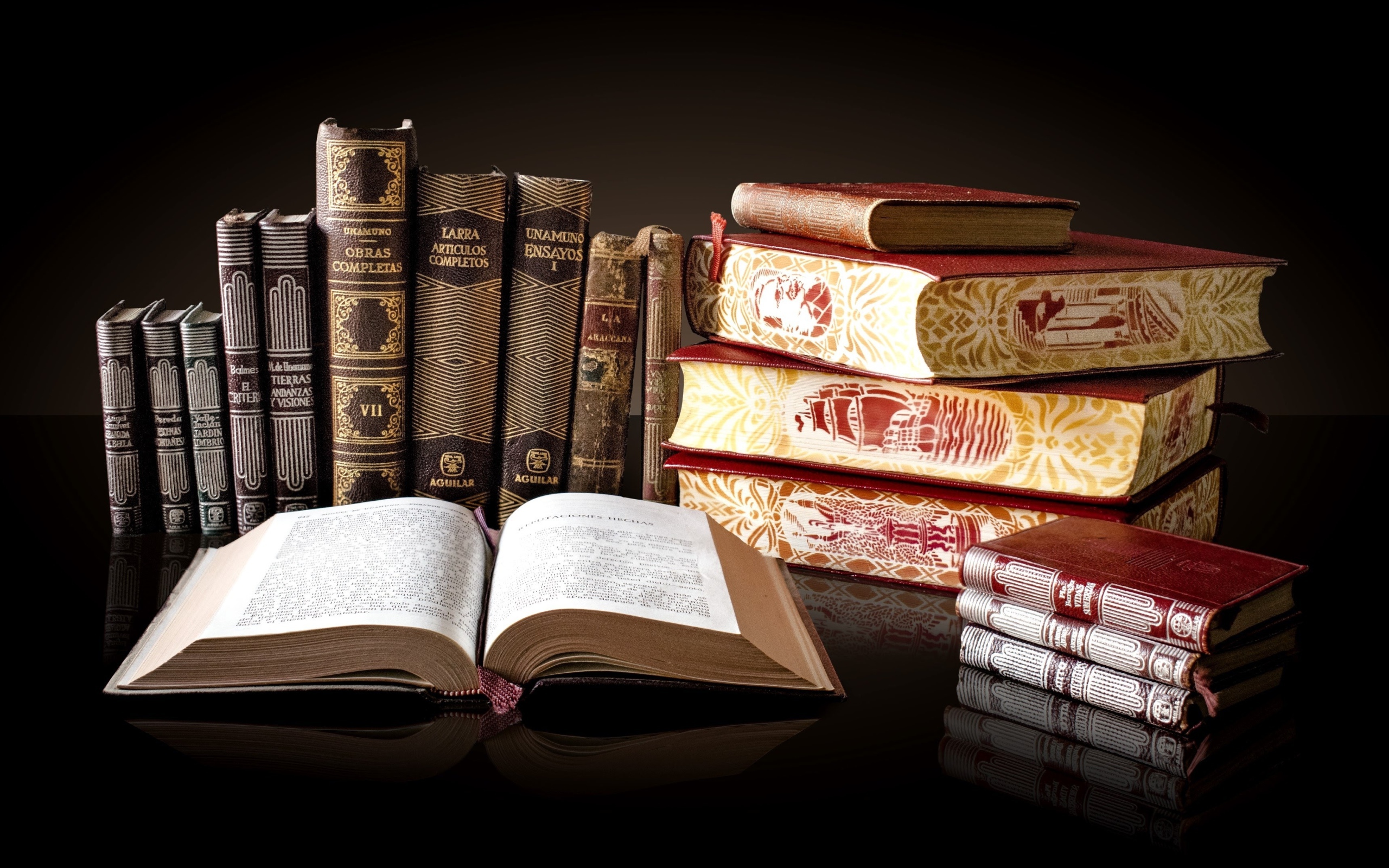 Красивые книги отражаются в зеркальной поверхности стола