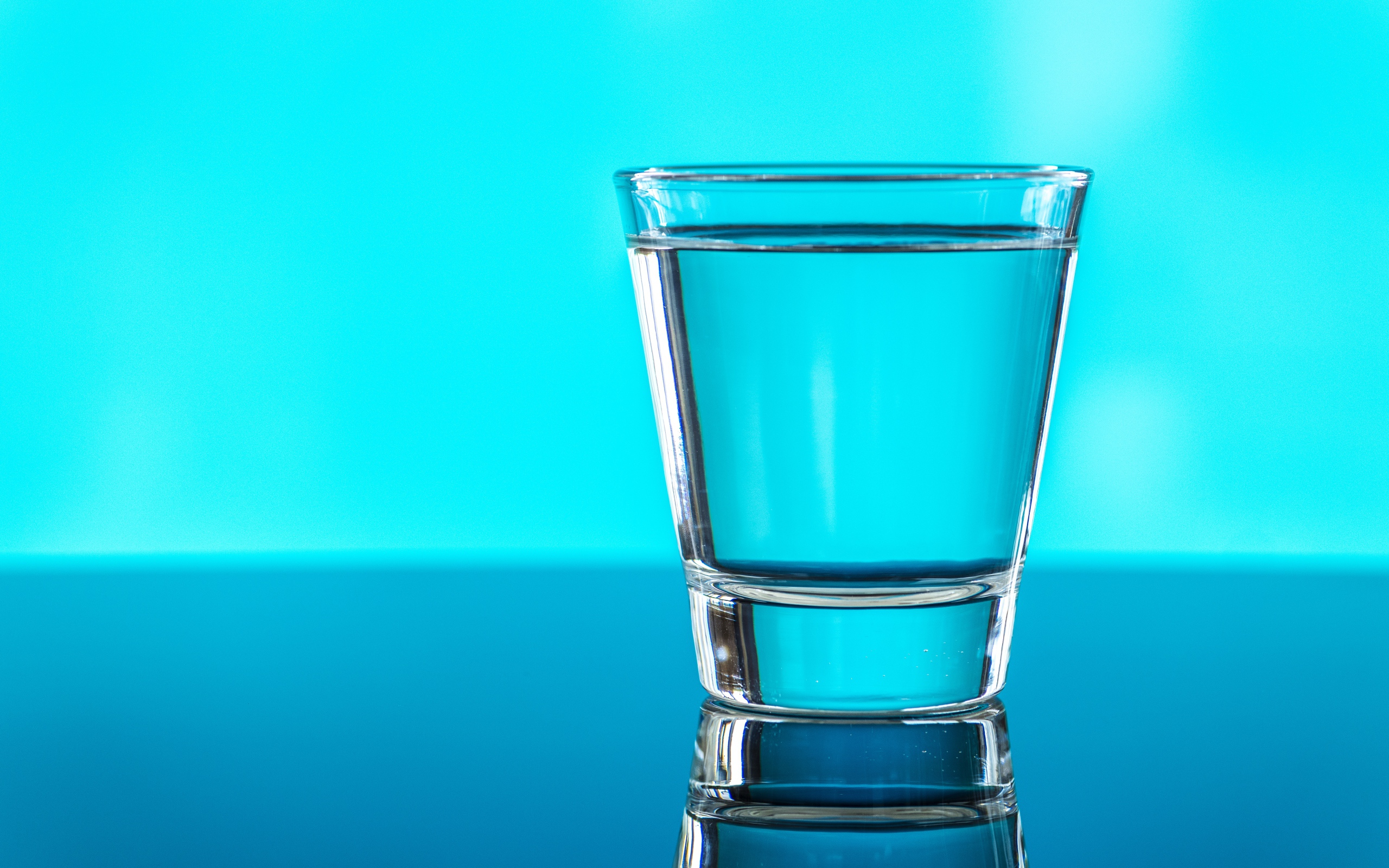 A glass of water on a blue background