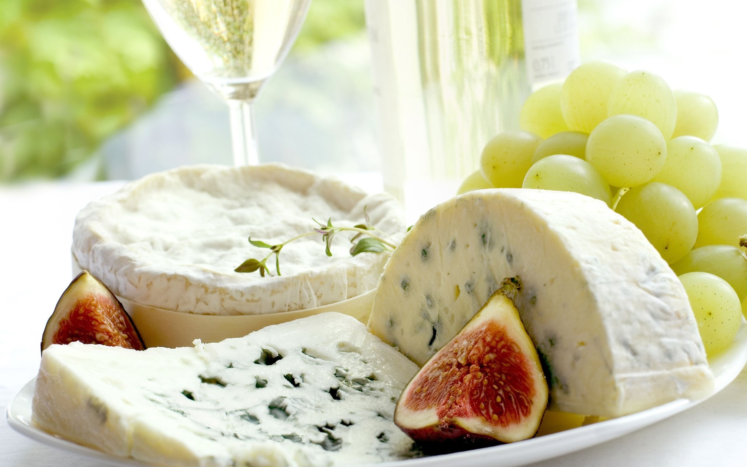 Expensive blue cheese on a plate with figs and white grapes