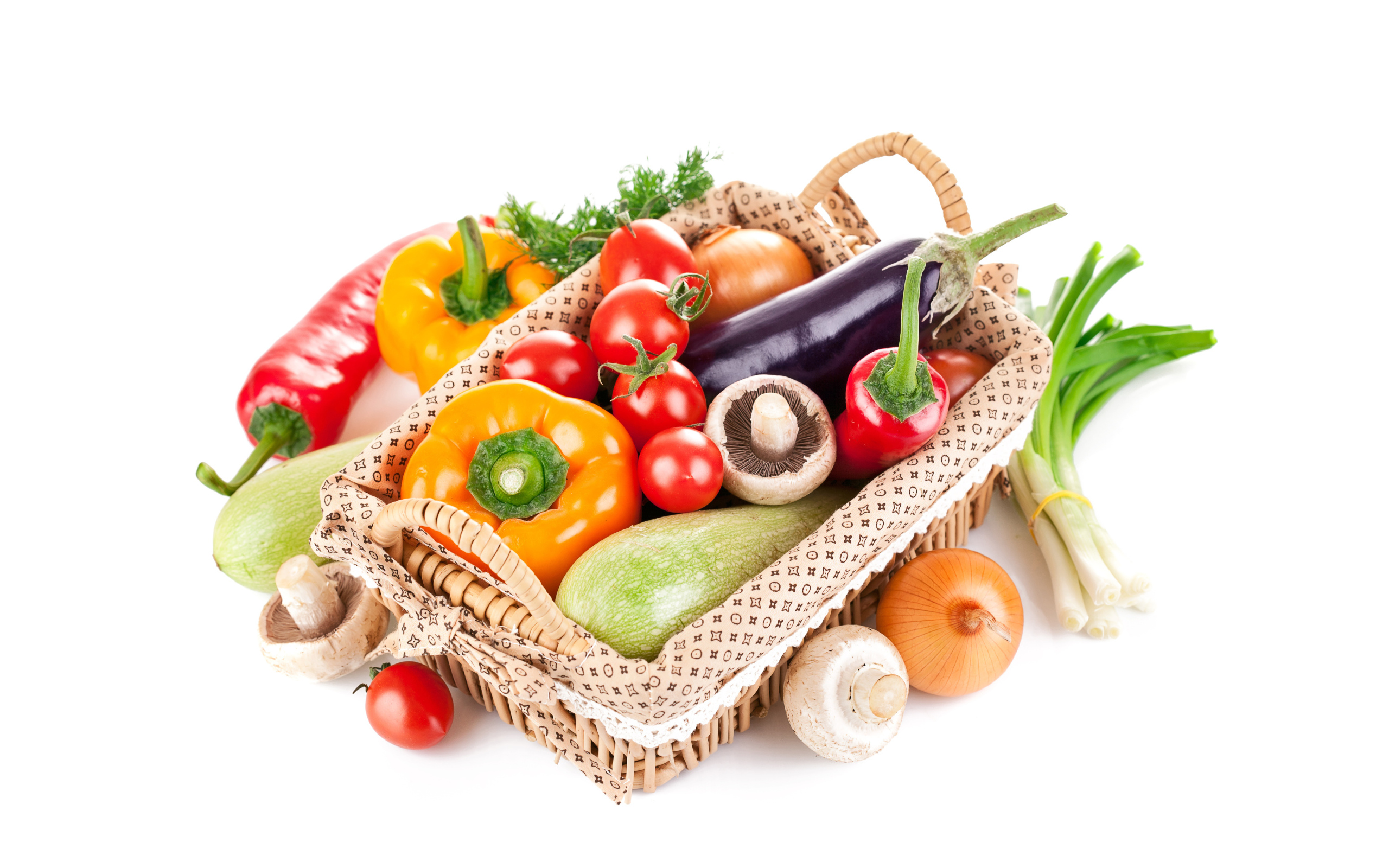 Fresh vegetables in a basket on a white background