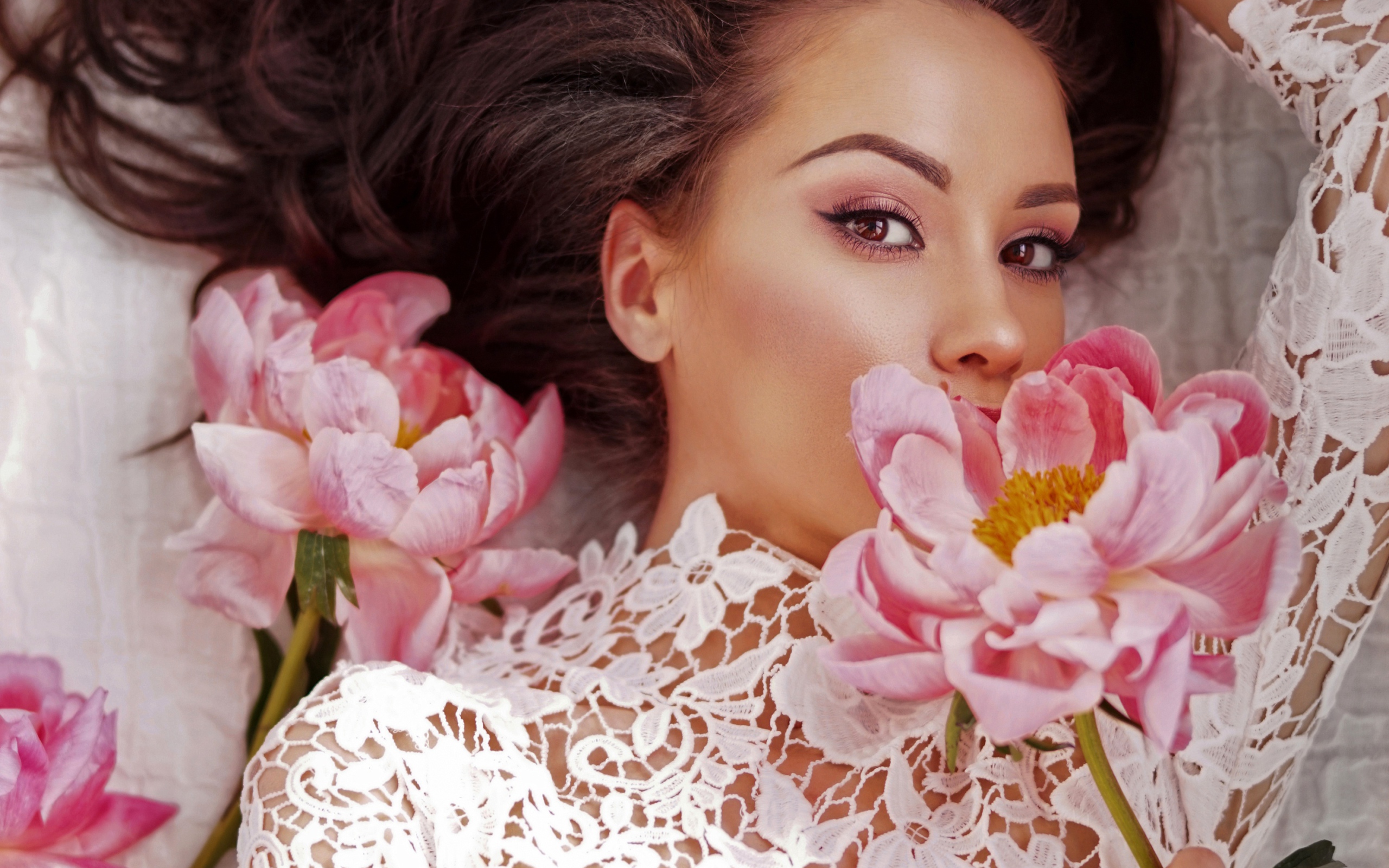 Красивая девушка в белом платье с розовыми цветами пиона 