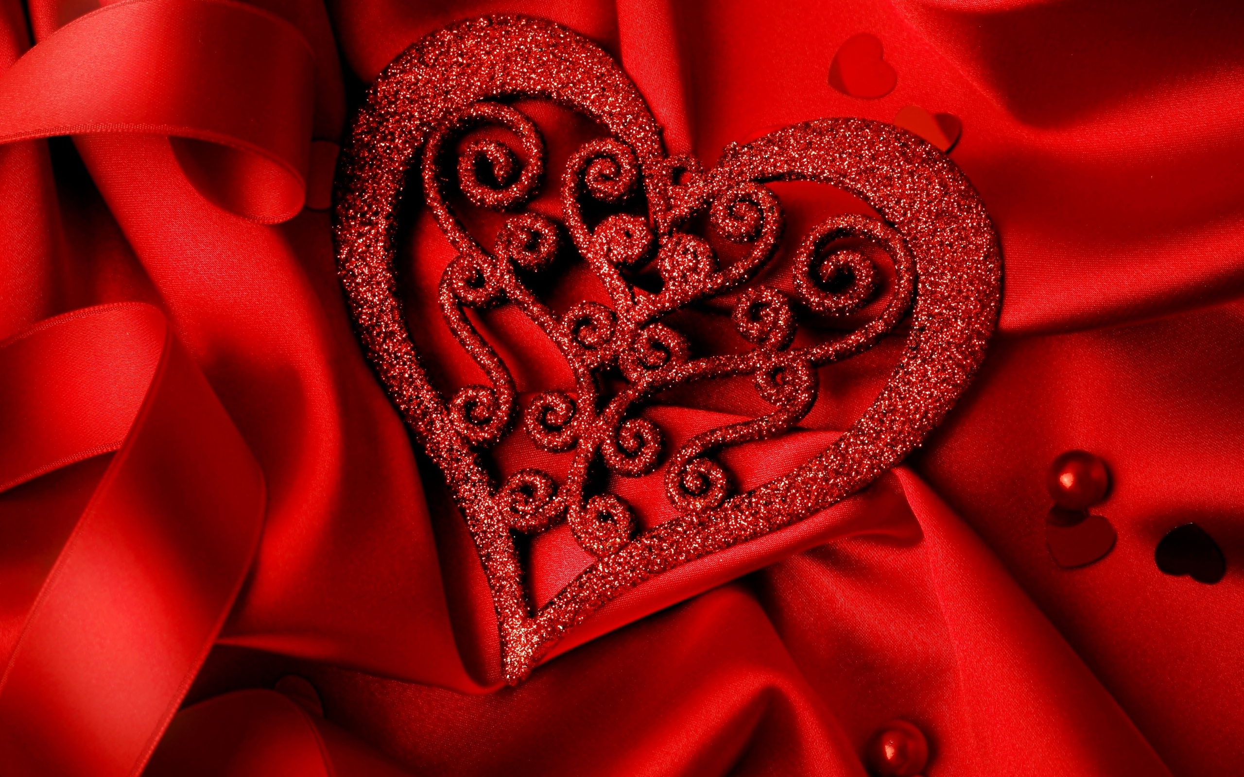 Brilliant heart on a red satin fabric