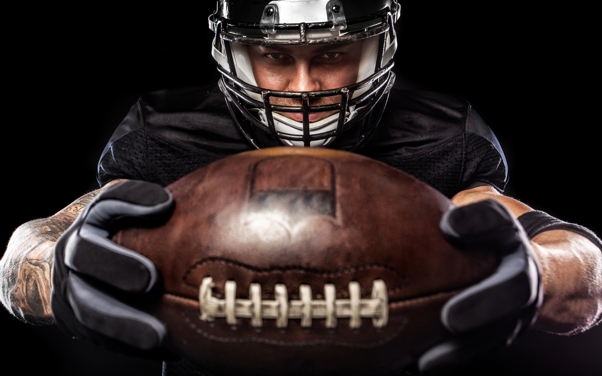 American football player with ball on black background Desktop wallpapers  2560x1600