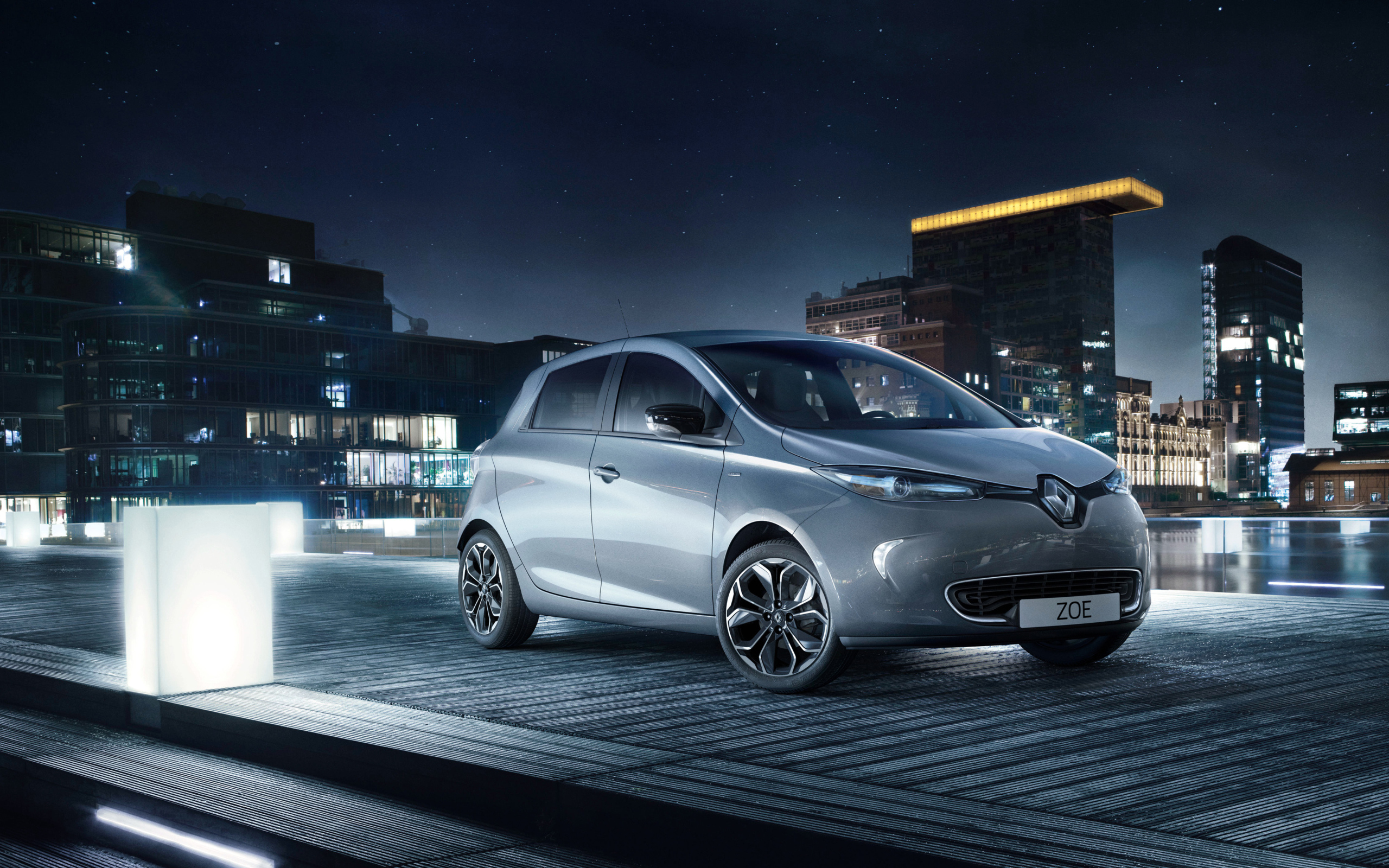 Маленький автомобиль Renault Zoe ZE Iconic на фоне города