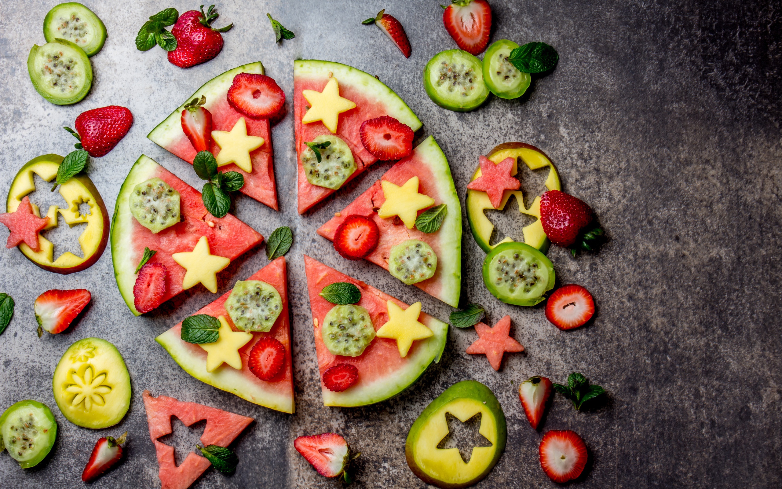 Кусочки арбуза с фруктами на сером фоне