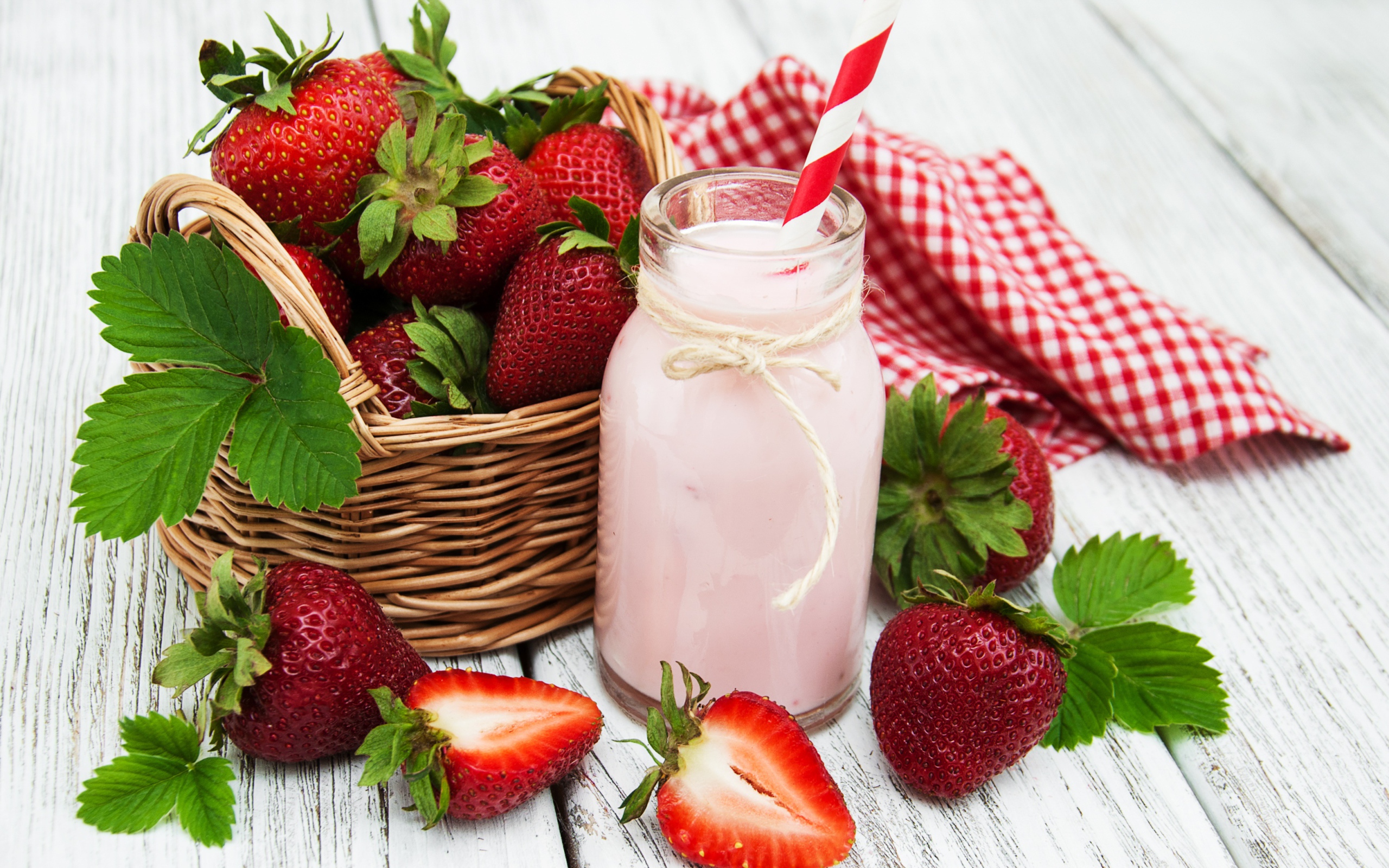 Банка с коктейлем на столе с ягодами клубники