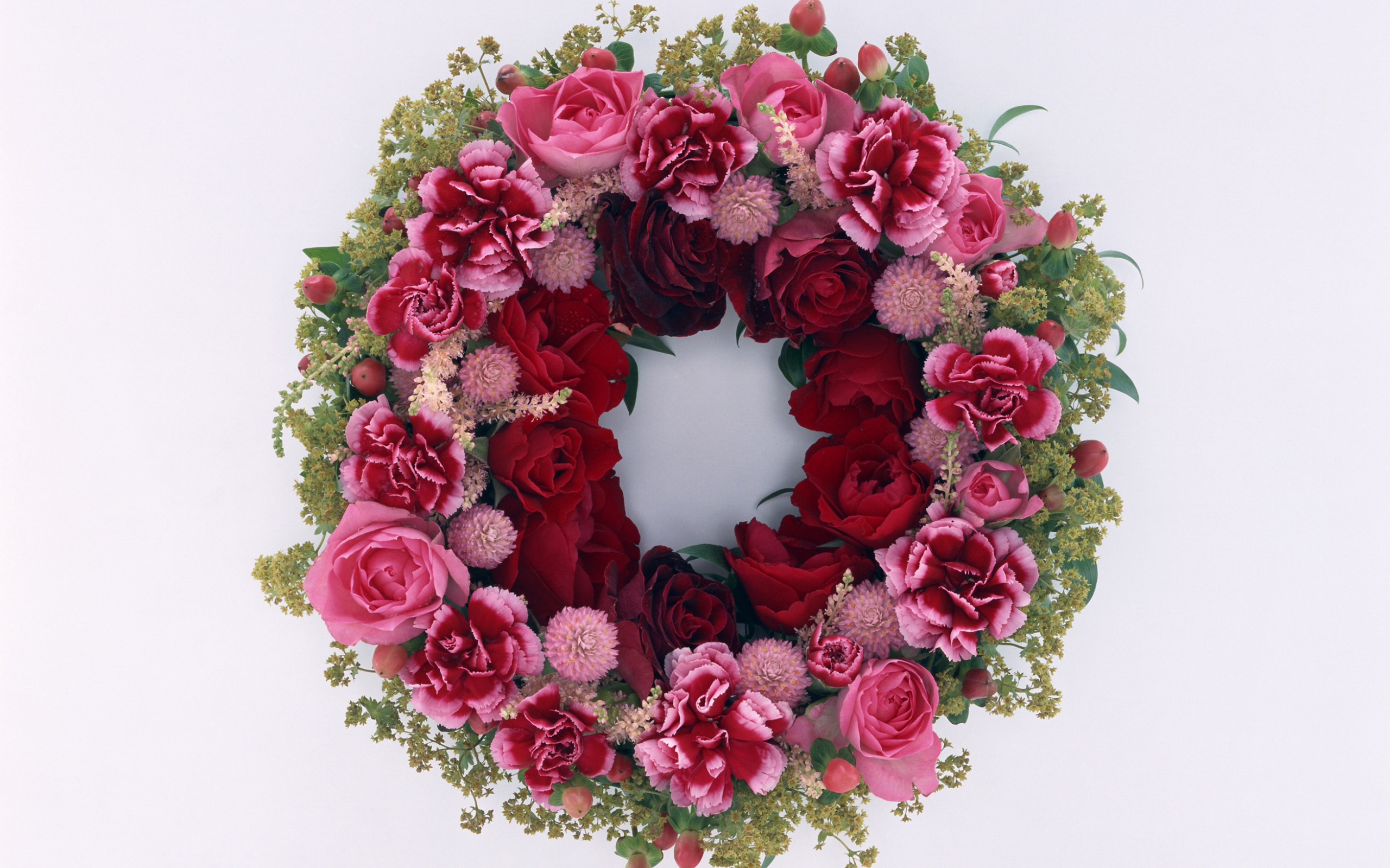 Wreath and red roses with carnation flowers on a gray background