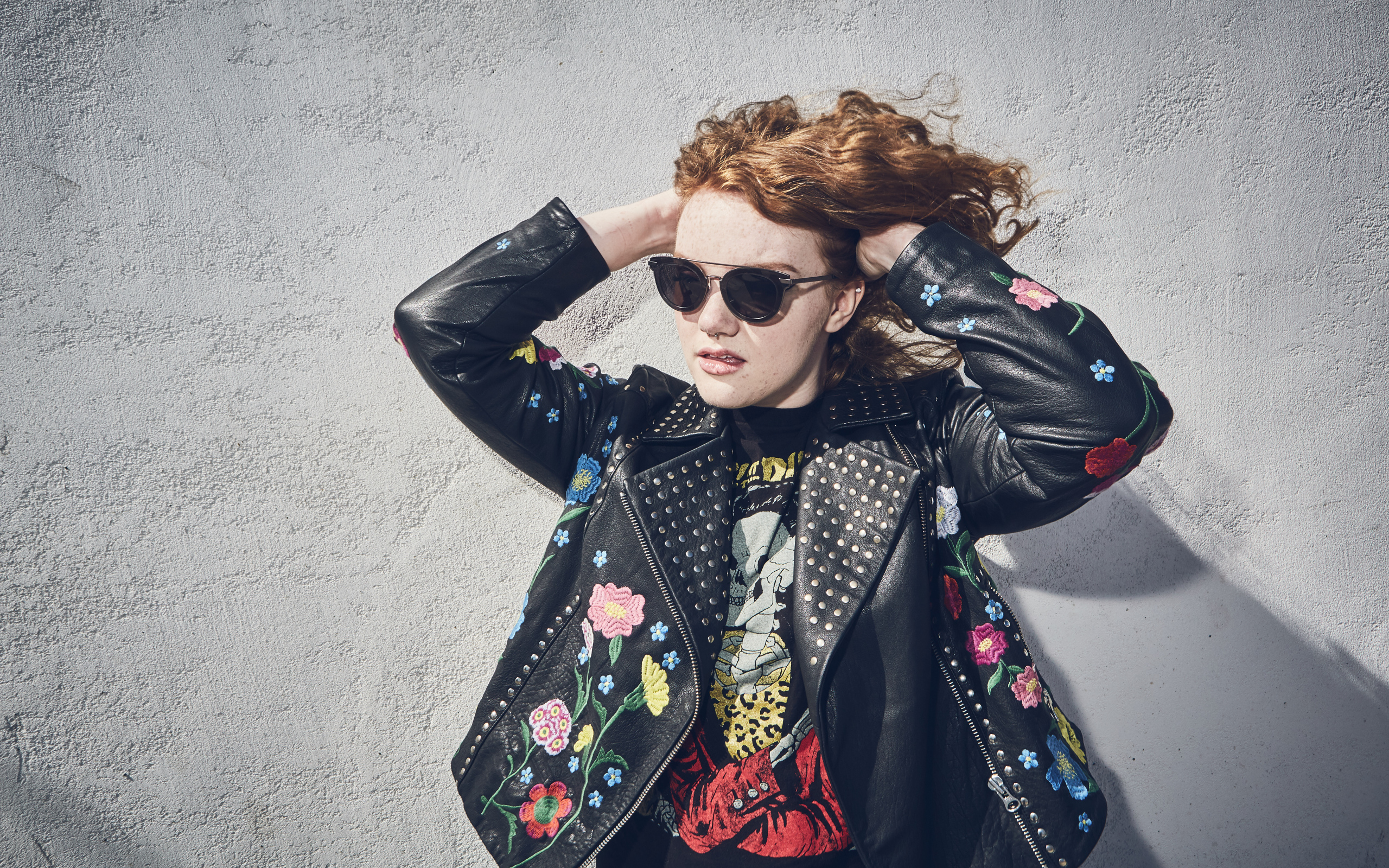 Актриса Шеннон Пёрсер в кожаной куртке у стены