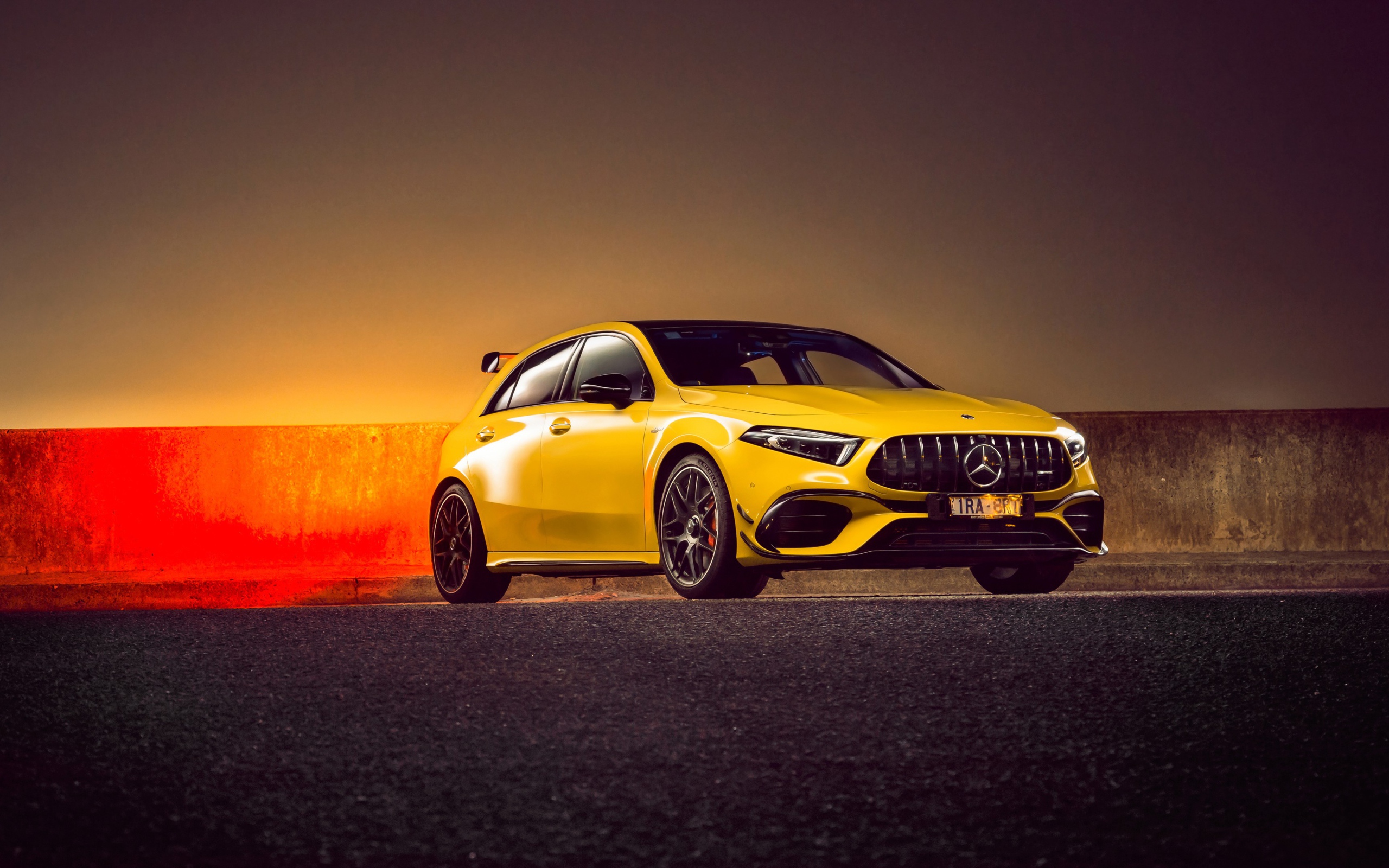 Желтый автомобиль Mercedes-AMG A 45 S,  2020 года на асфальте 