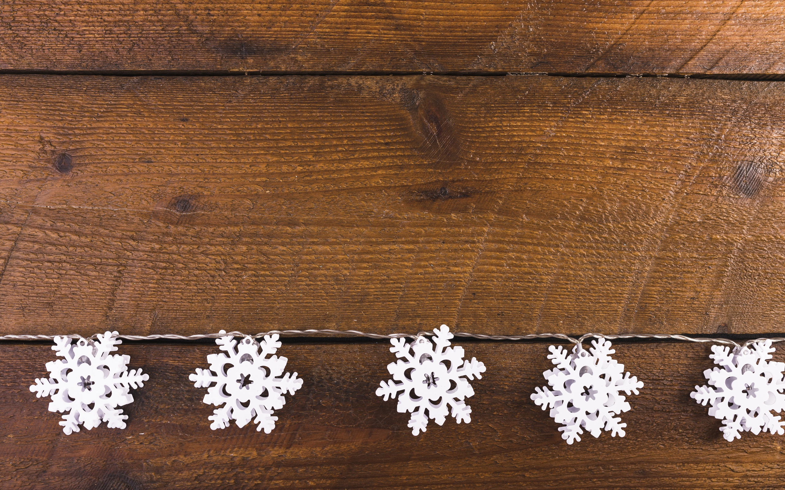 White snowflakes on a wooden background