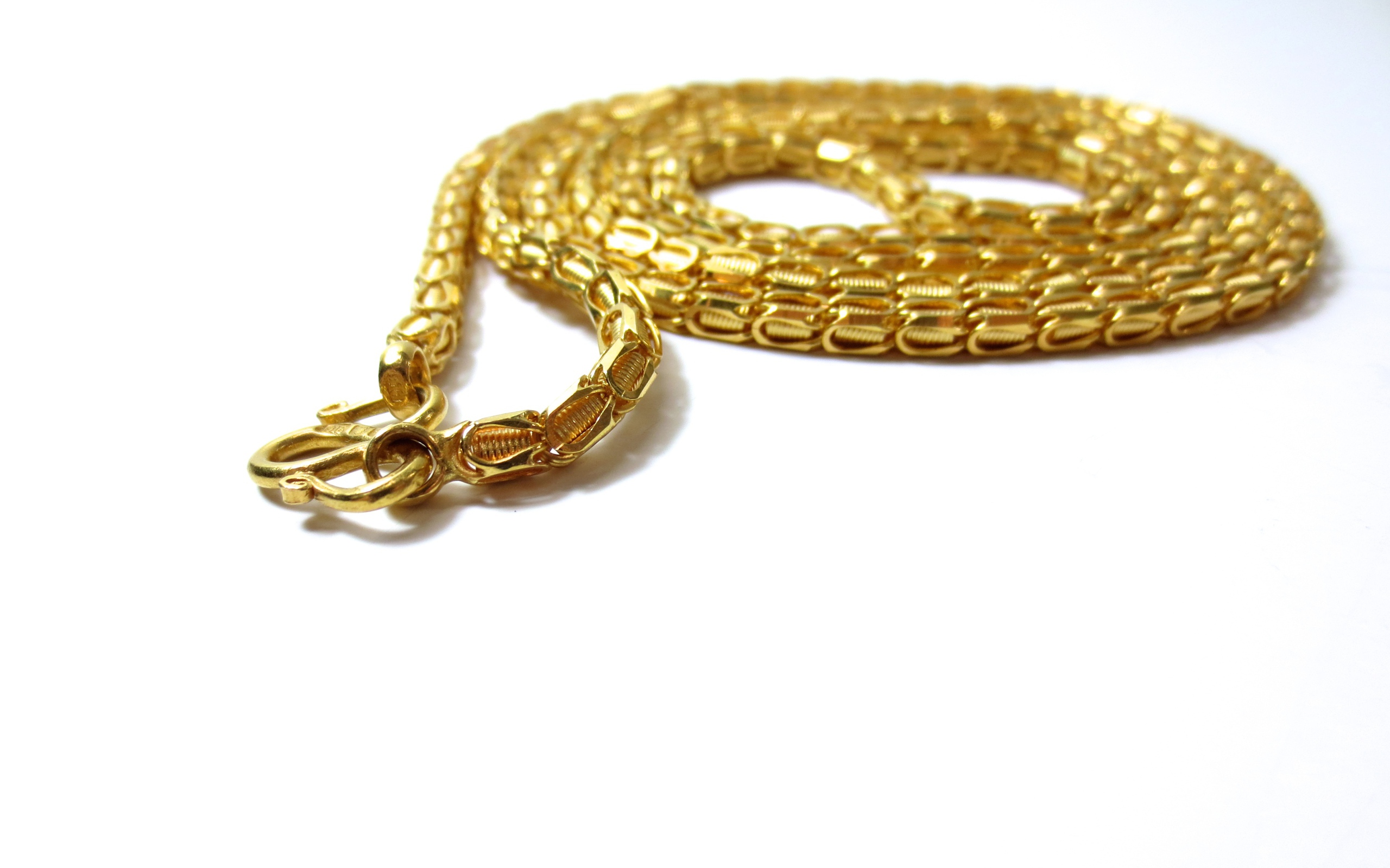 Big expensive gold chain on white background