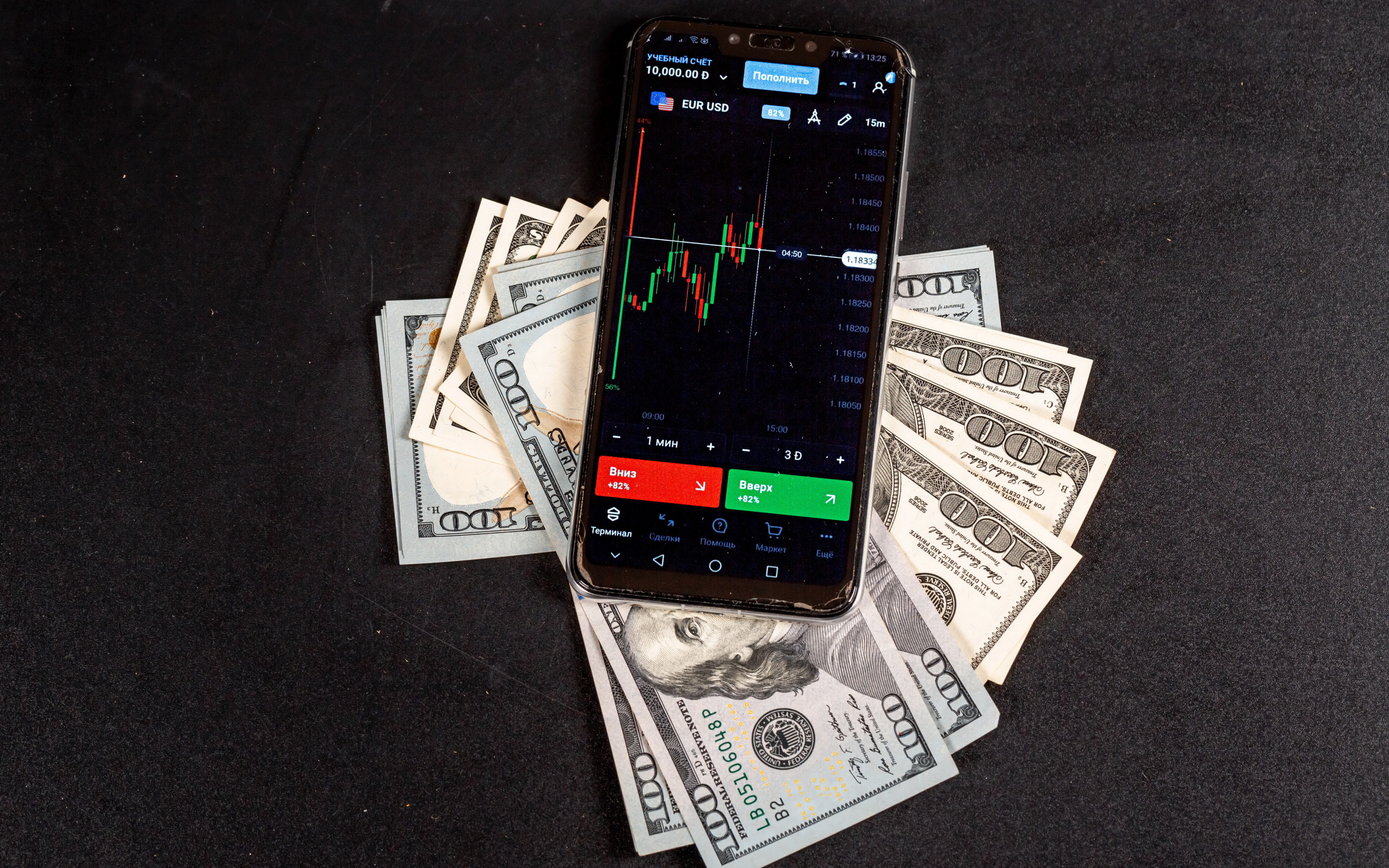 Доллары и смартфон на сером столе 
