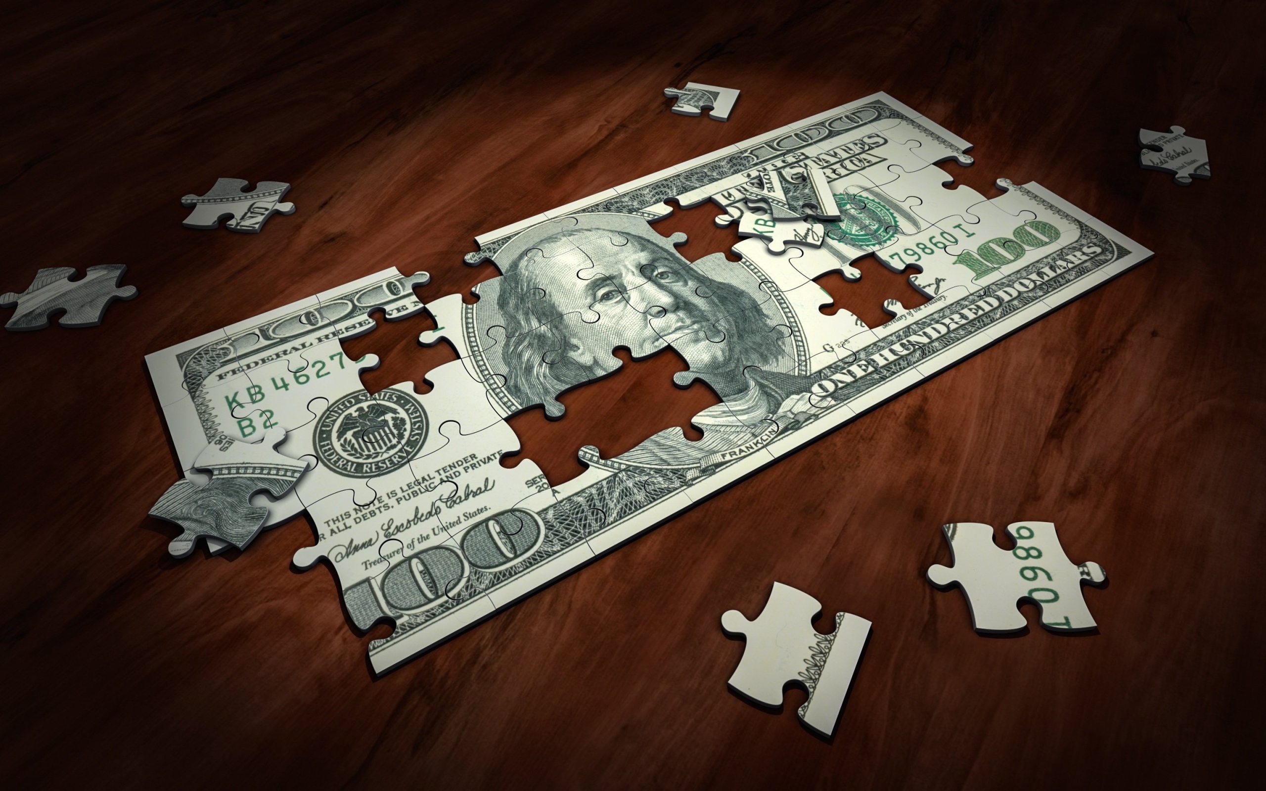 Пазл из купюры сто долларов на столе 