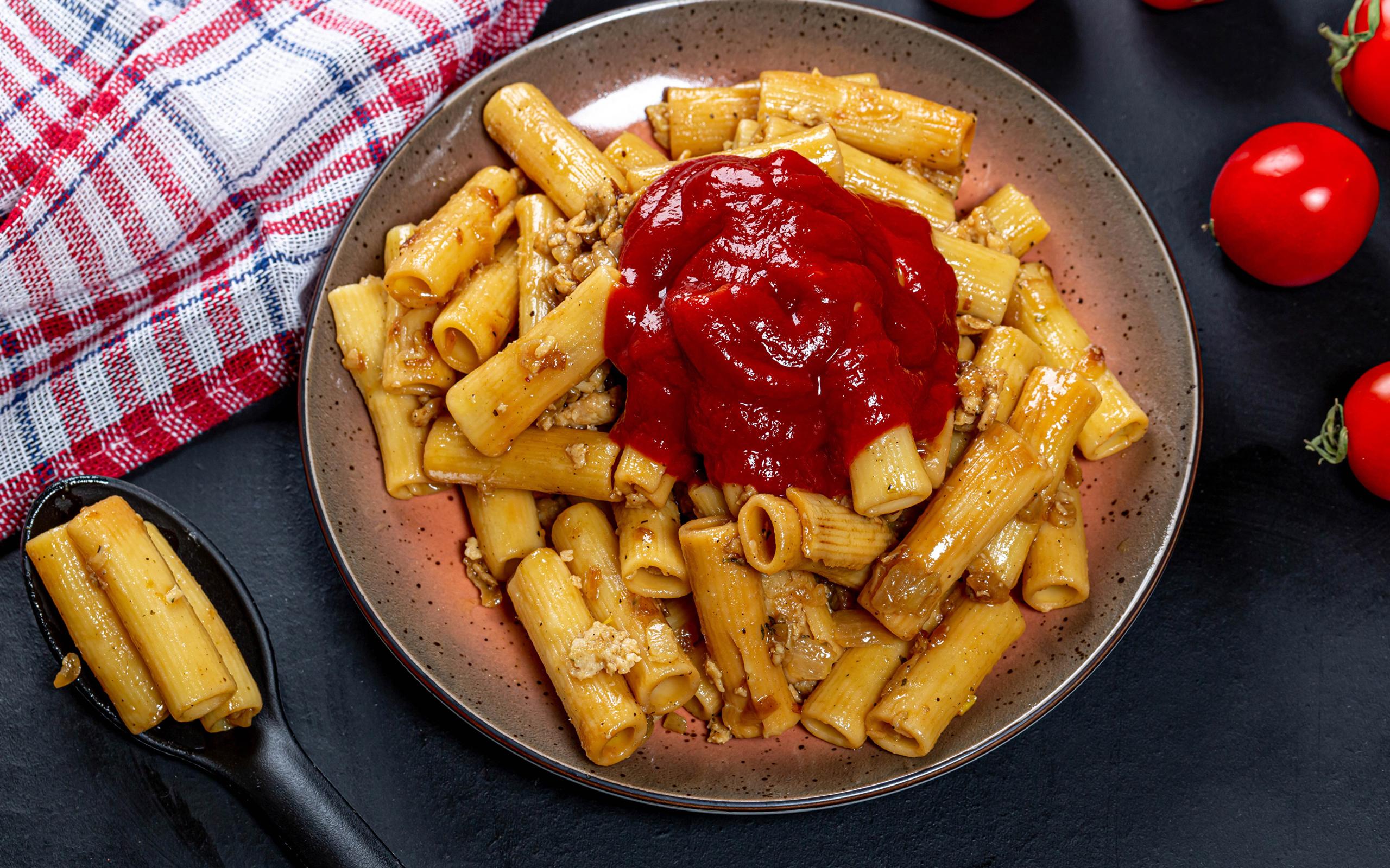 Pasta with meat and ketchup on the table