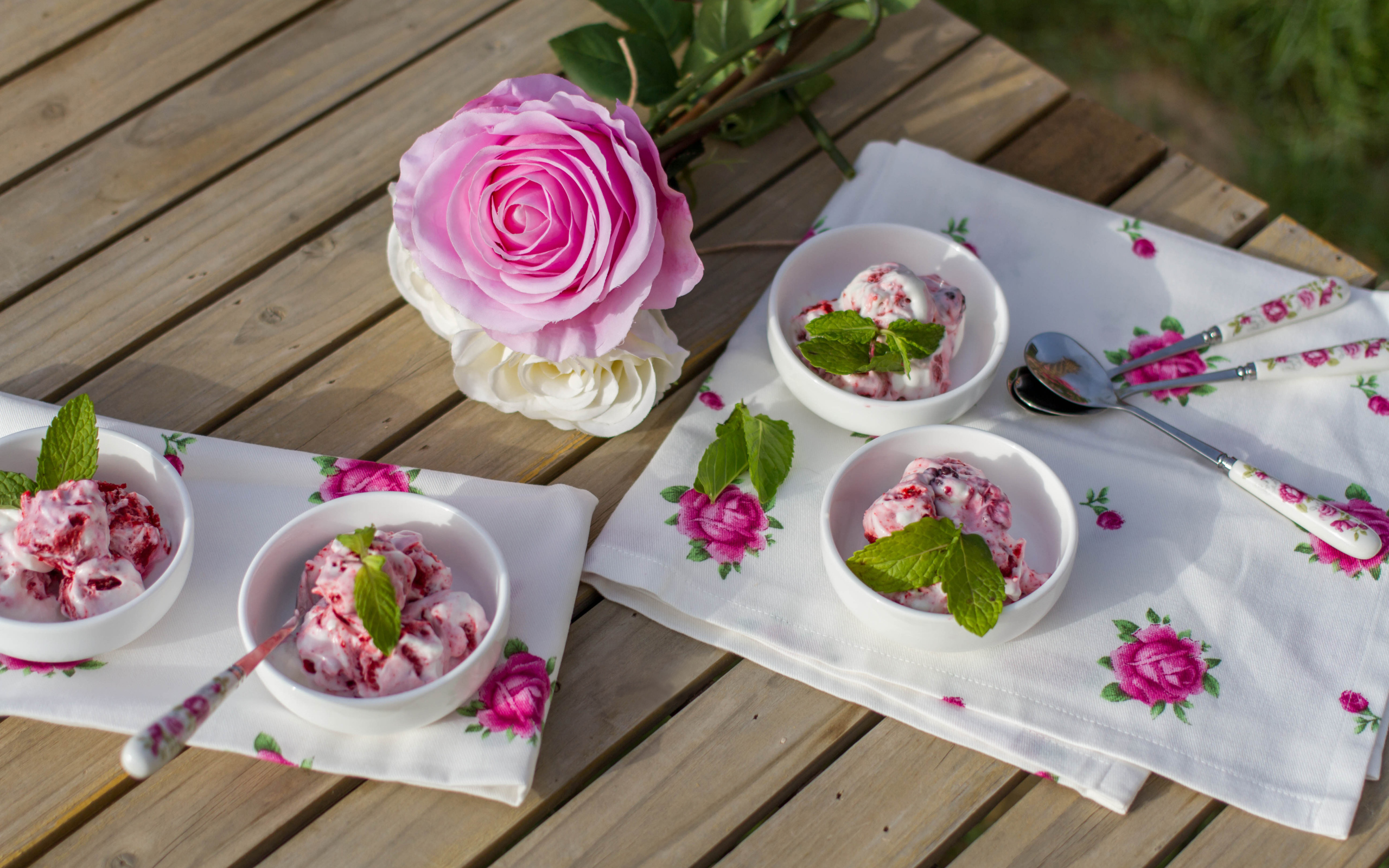 Ice cream on a table with a pink rose