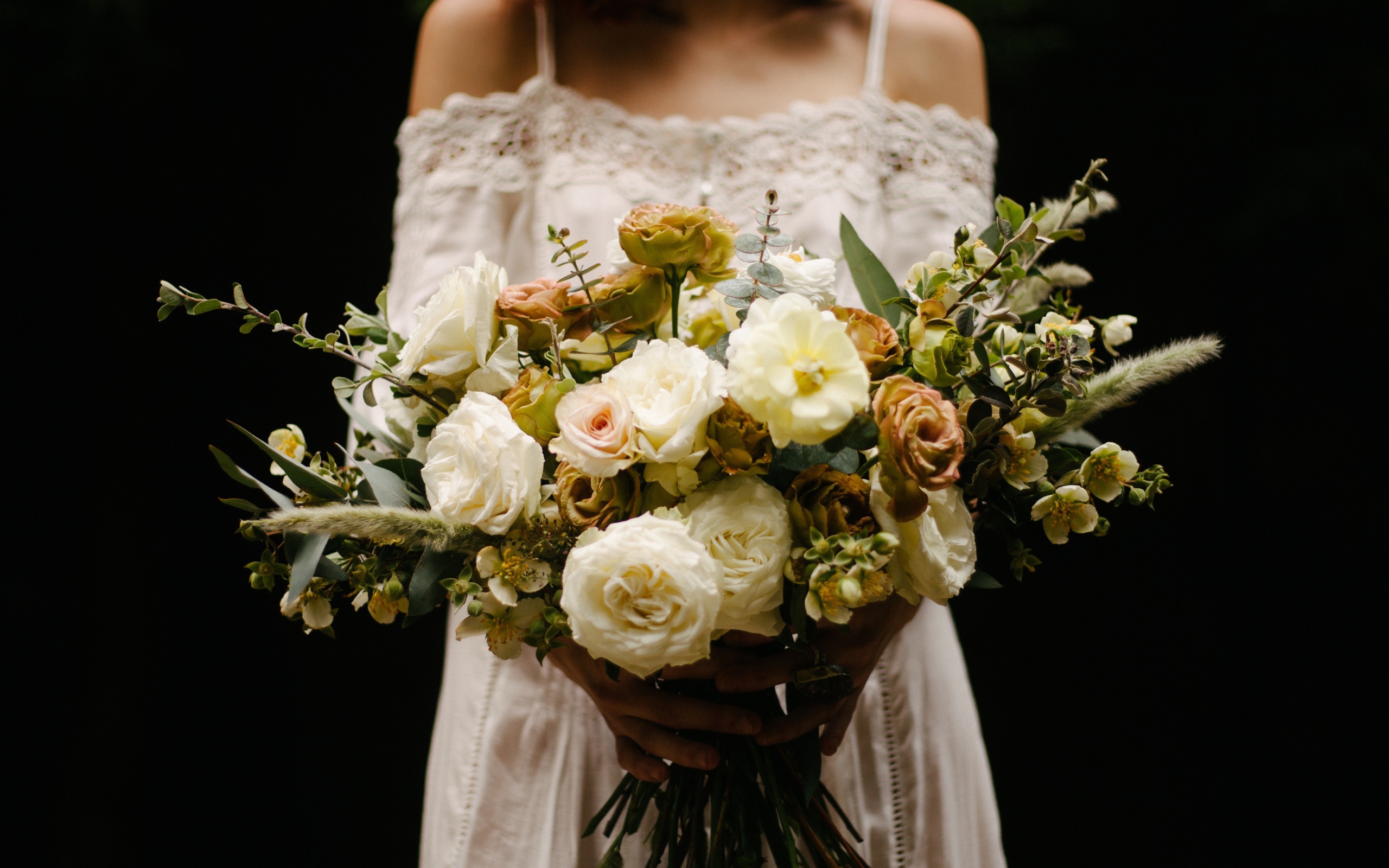 Beautiful bridal bouquet with white roses in hands