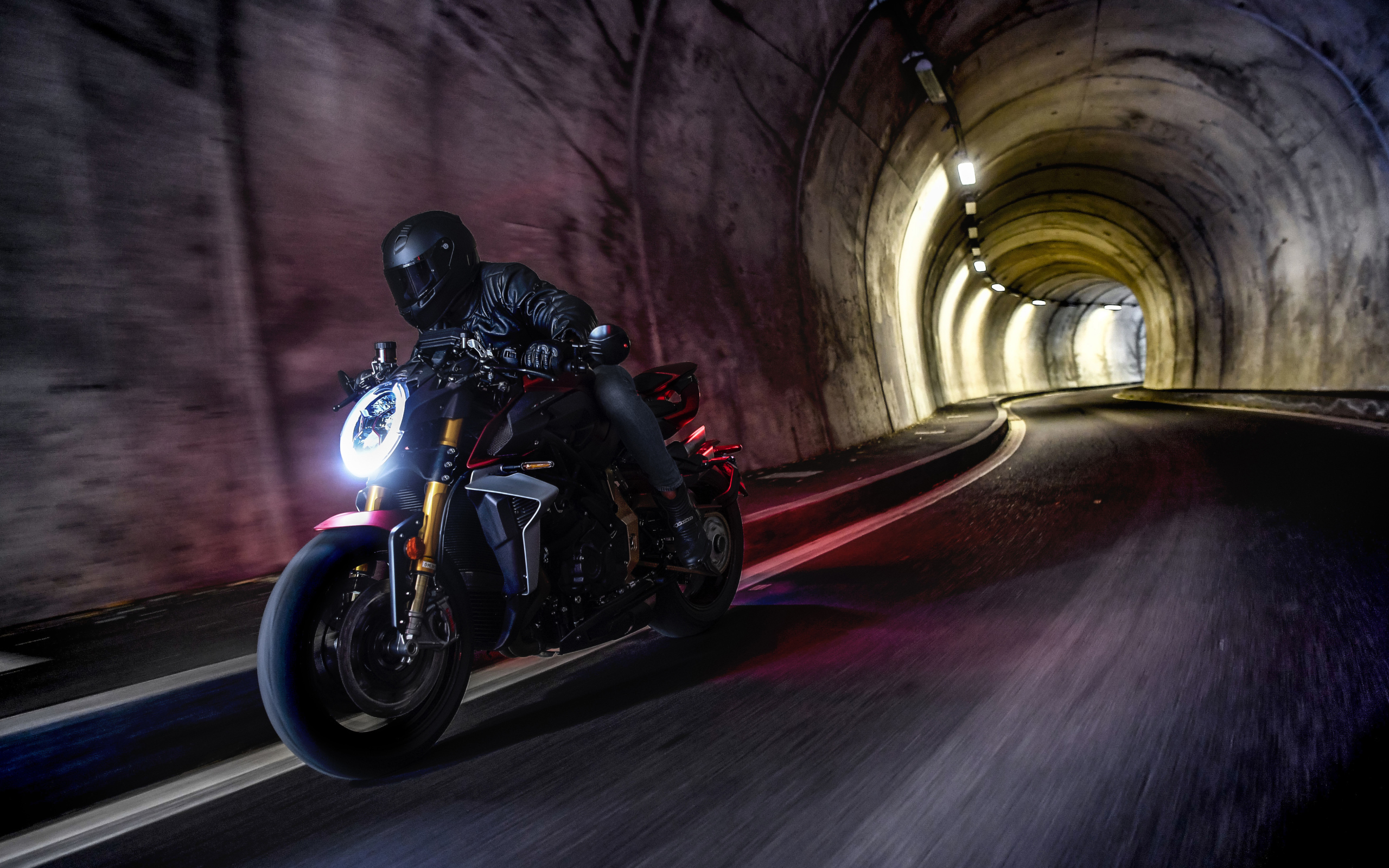 Motorcyclist on a motorcycle MV Agusta Brutale 1000 Serie Oro 2019 in the tunnel