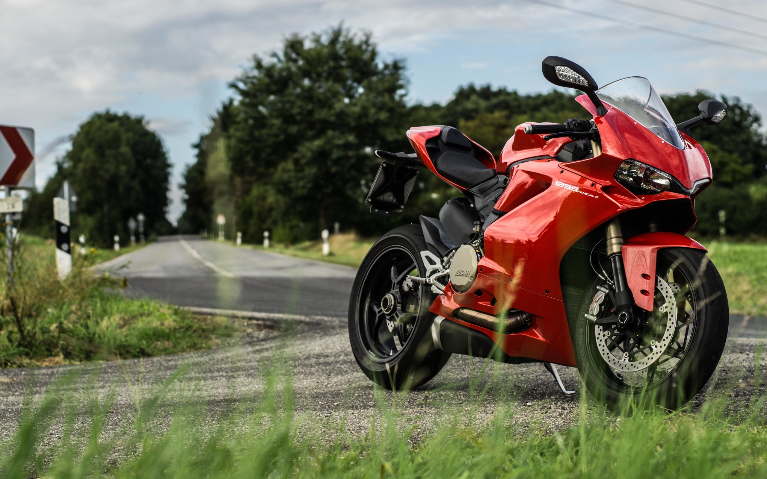 Красны мотоцикл Ducati 1299 Panigale на трассе 