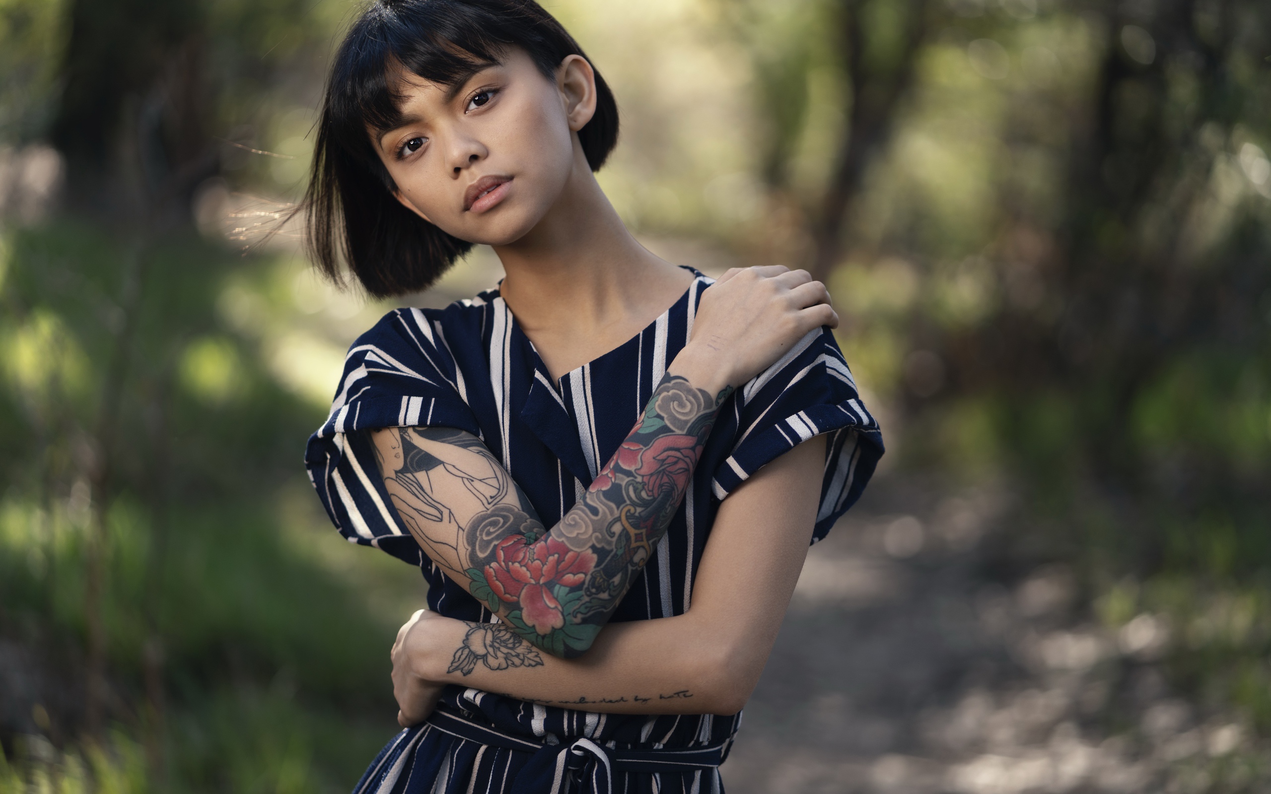 Beautiful Asian girl with tattoos in her arms
