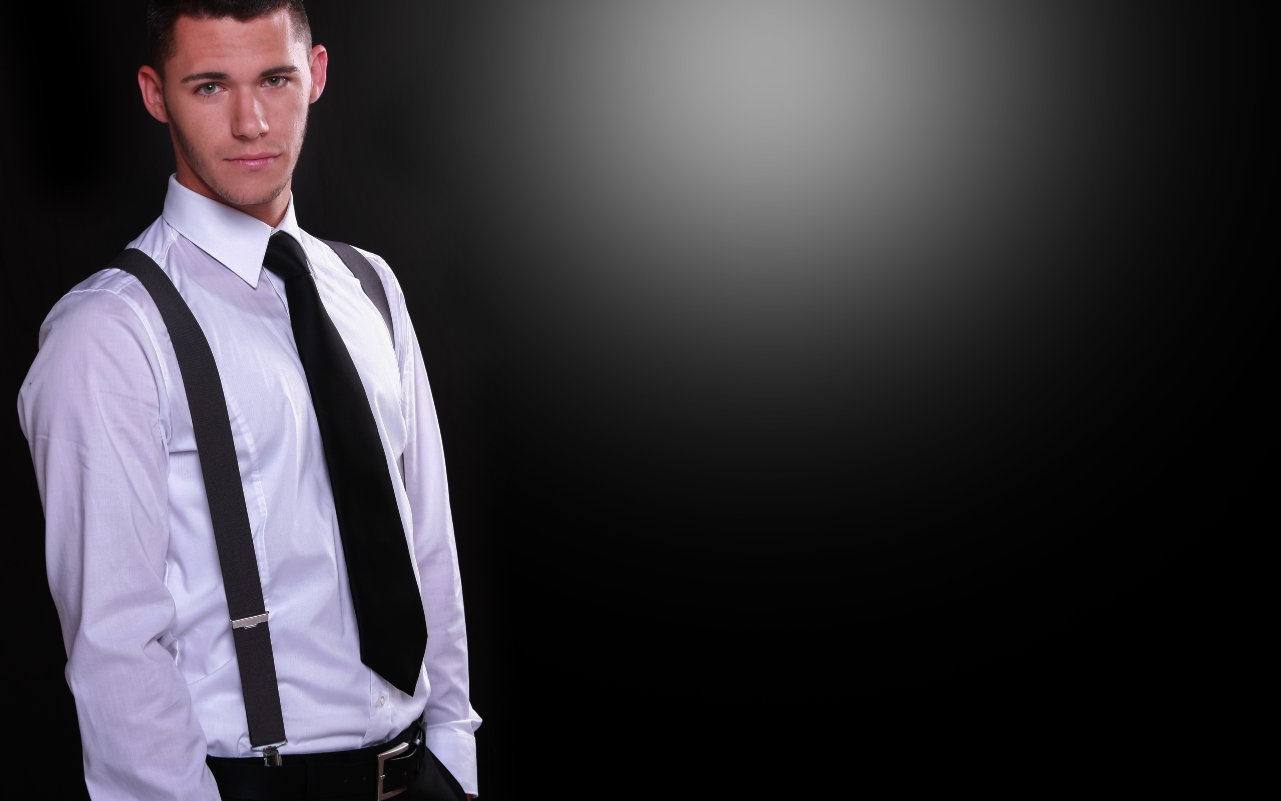 Красивый парень в белой рубашке на черном фоне 