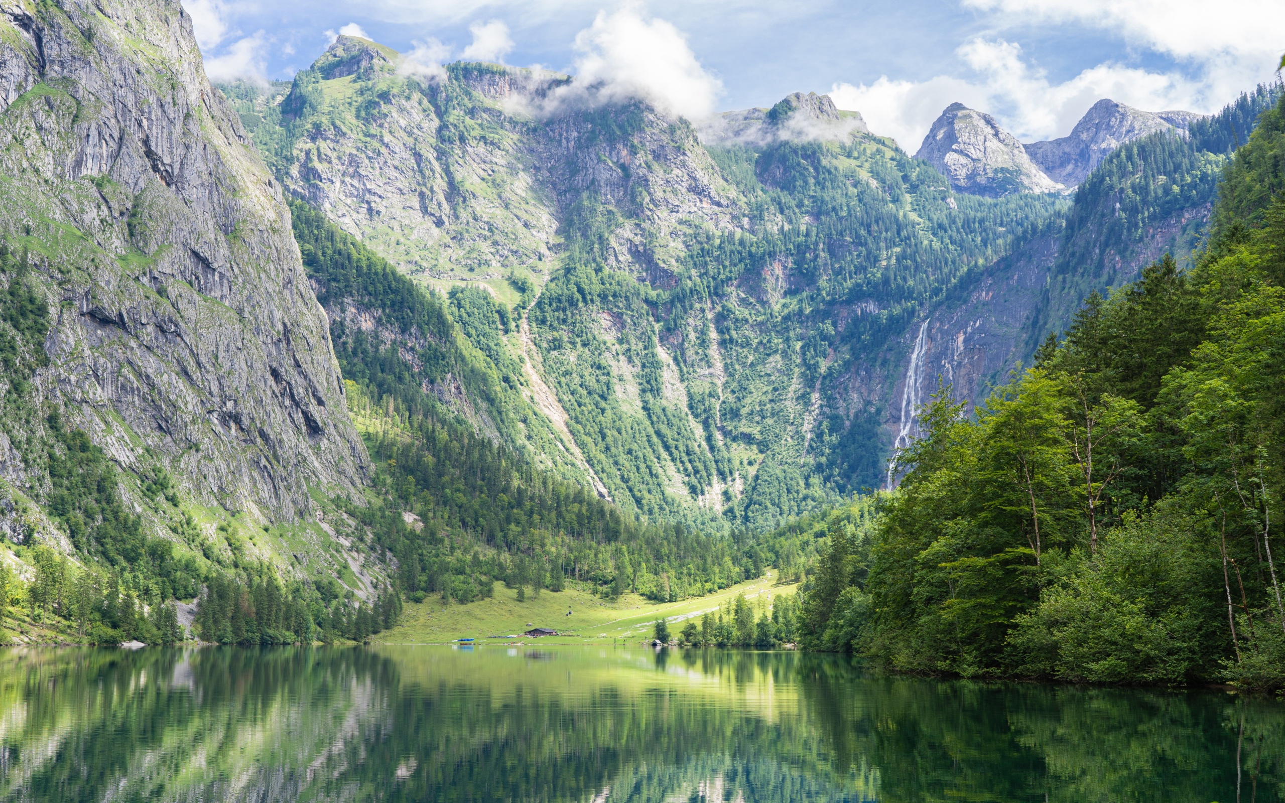 High mountains by the lake with green trees