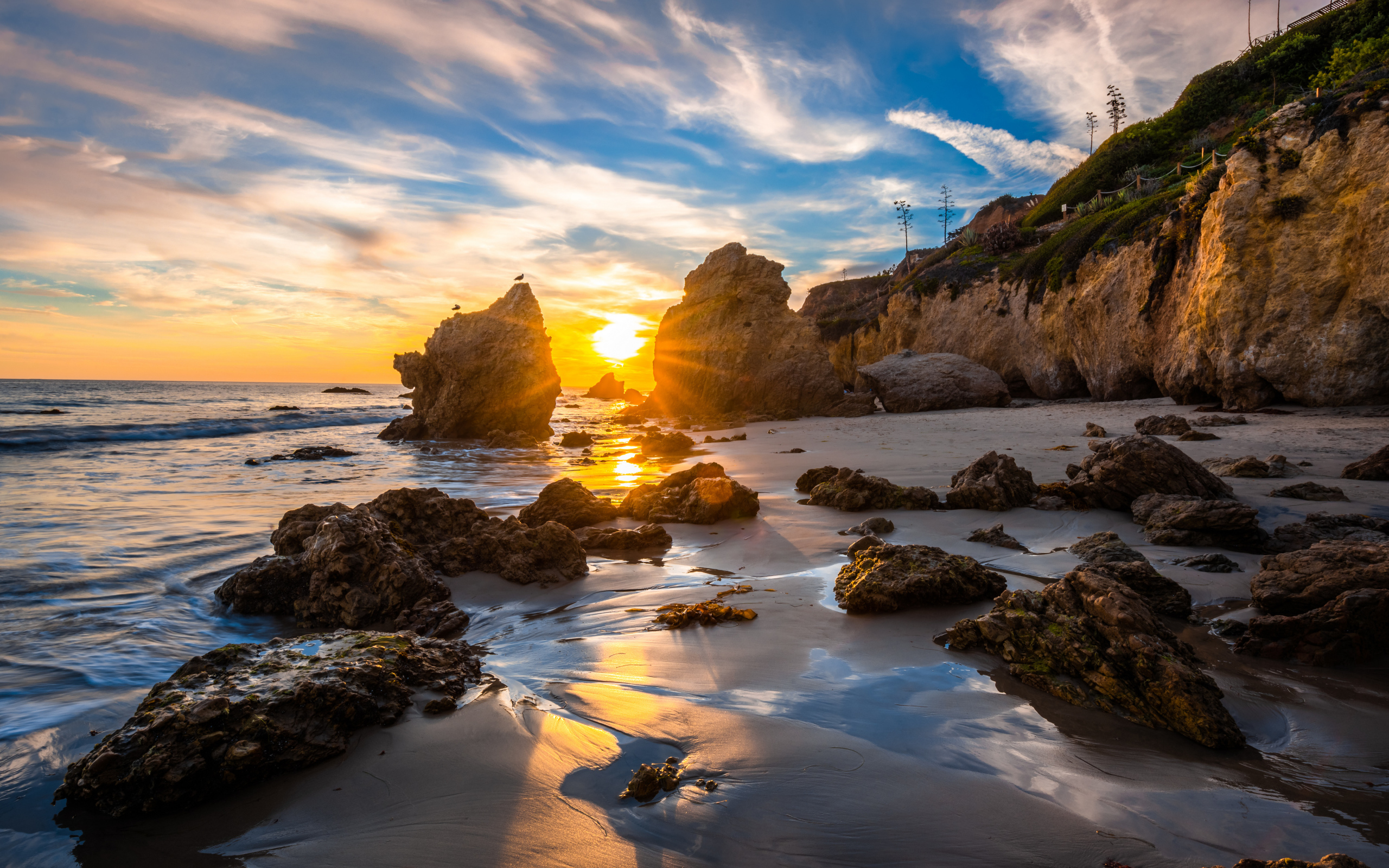 Яркий рассвет летнего солнца над скалами и океана