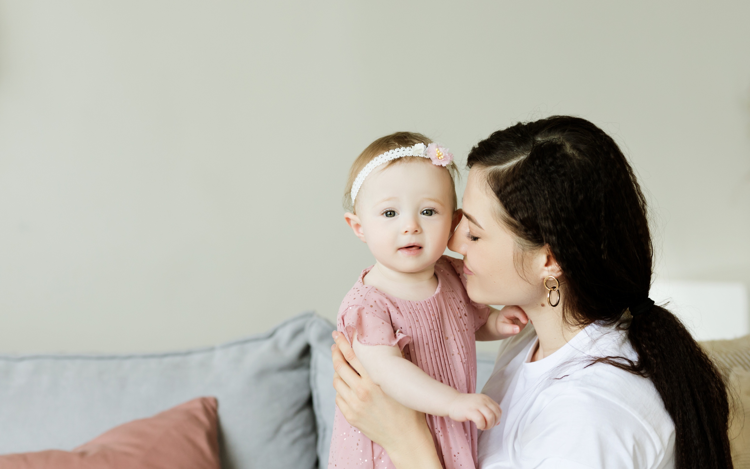 Маленькая девочка с мамой на сером фоне