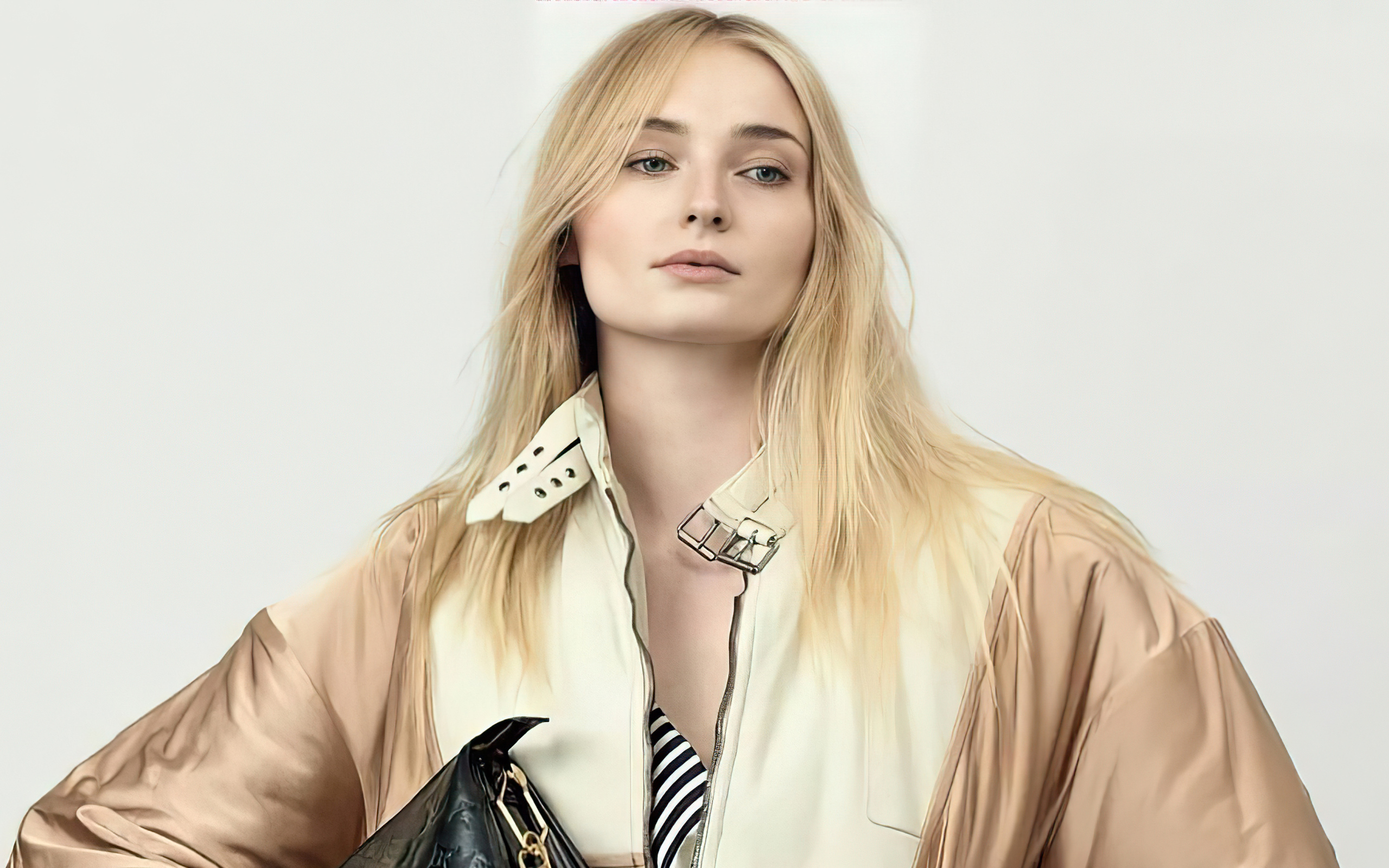 Актриса Софи Тёрнер в куртке на белом фоне