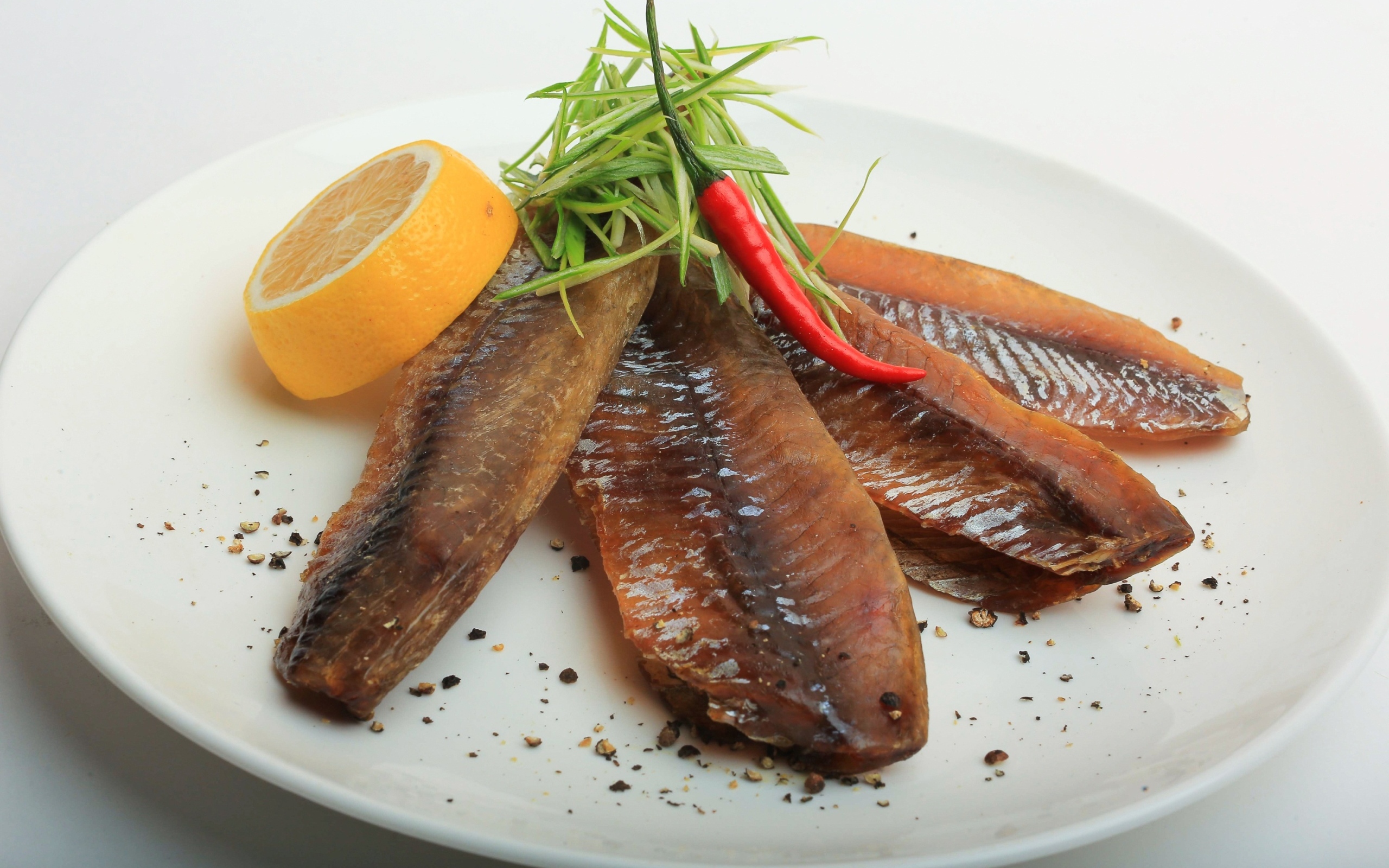 Вяленая вобла с куском лимона на тарелке