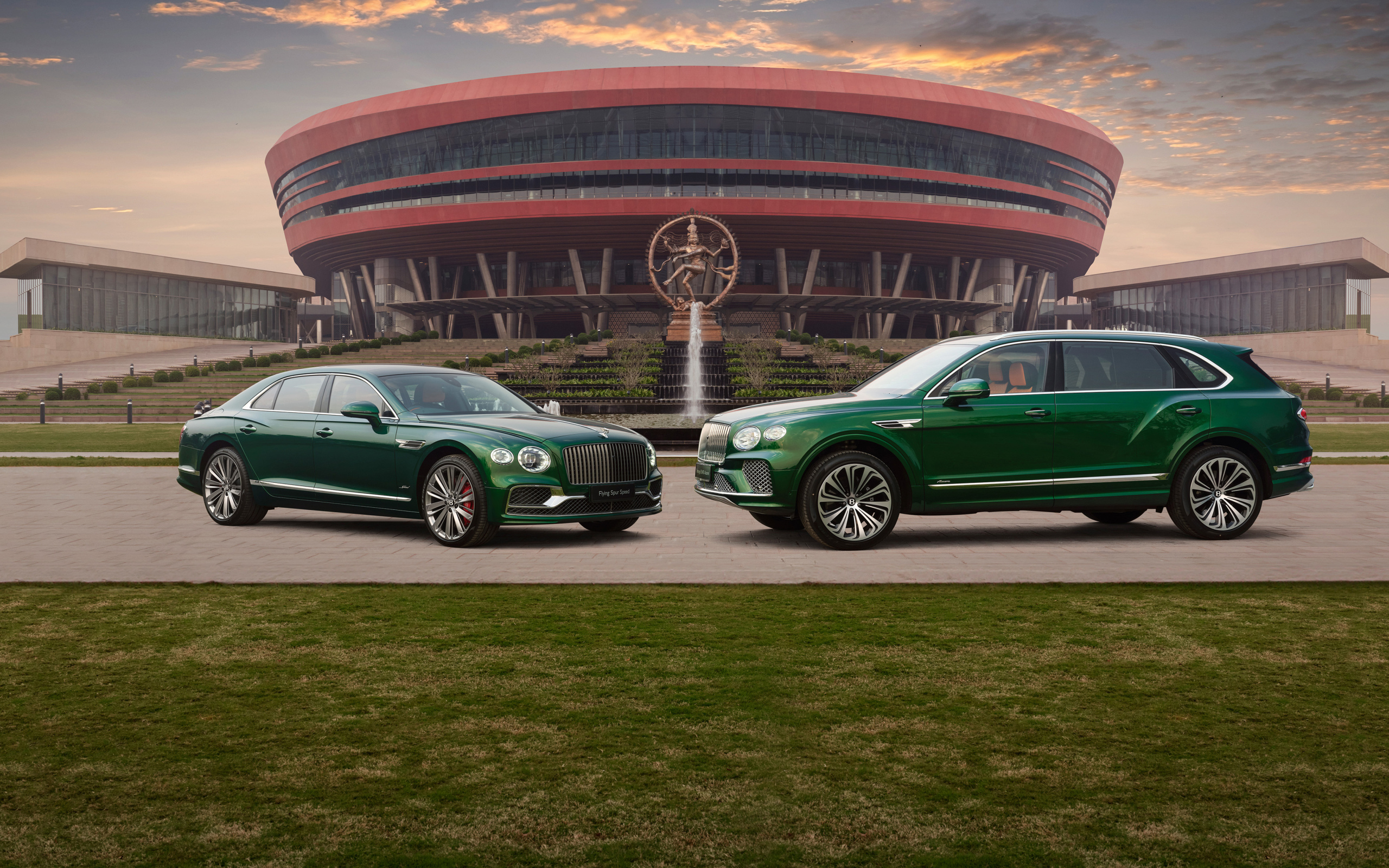 Два зеленых автомобиля Bentley  у здания