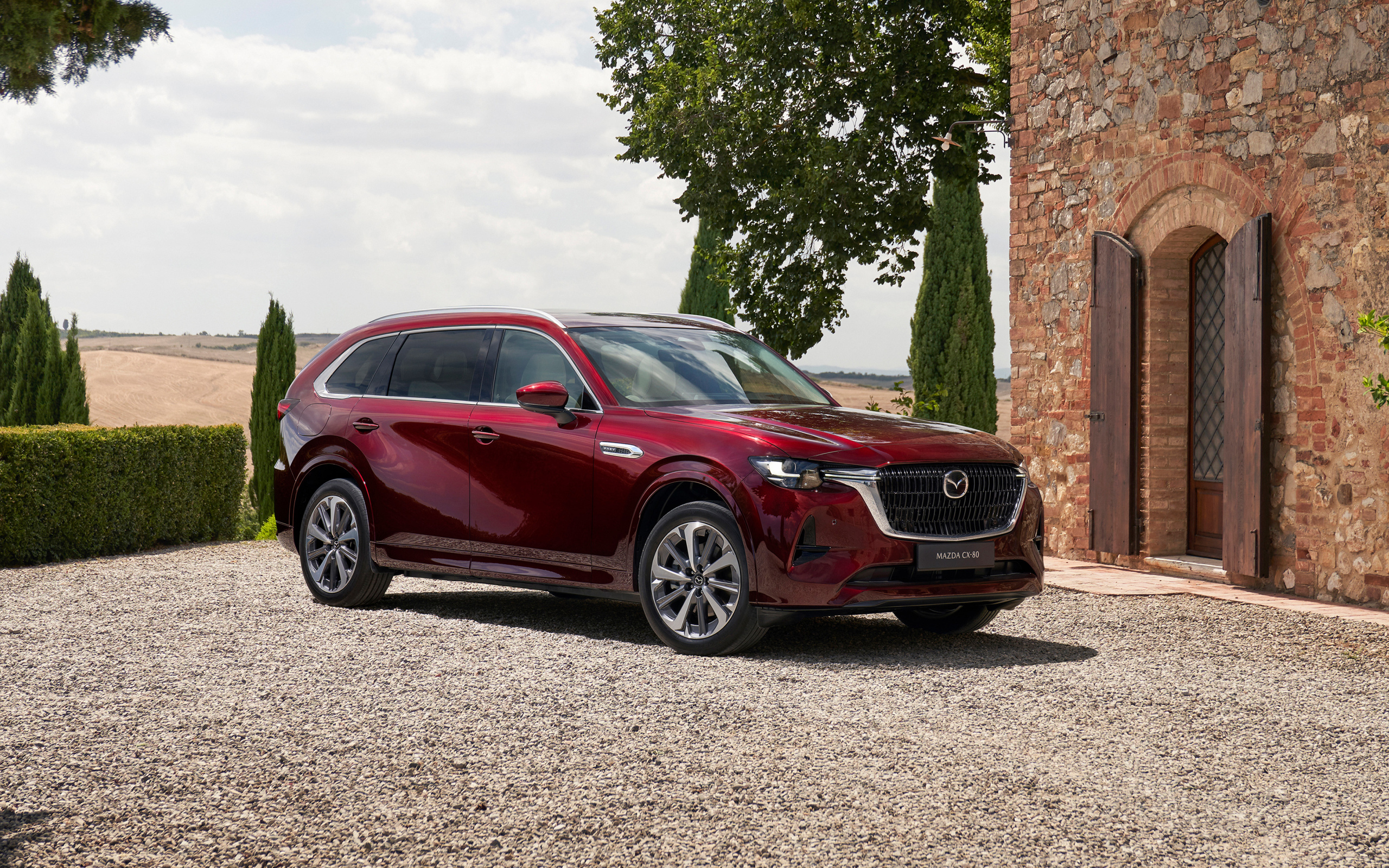 Бордовый автомобиль  Mazda CX-80 E-Skyactiv PHEV AWD 2024 года