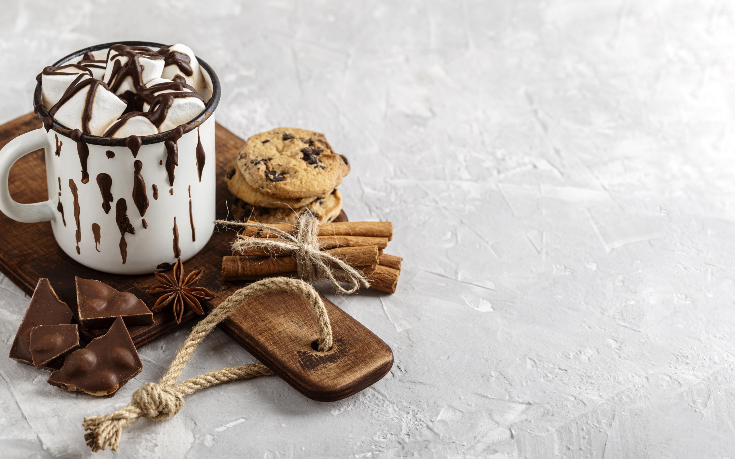 Горячий шоколад с маршмеллоу на столе с печеньем и конфетами