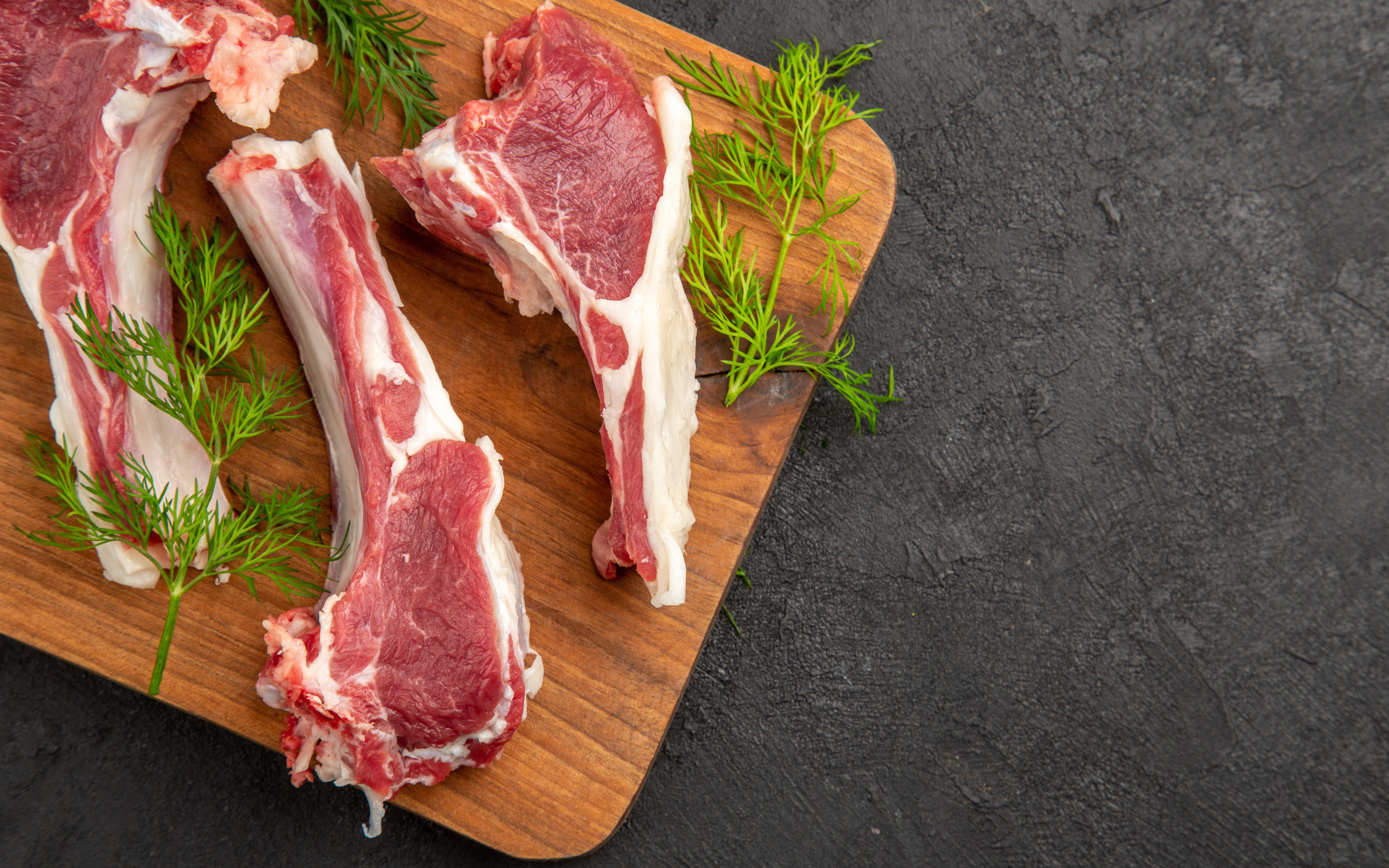 Свиные ребра на разделочной доске с укропом
