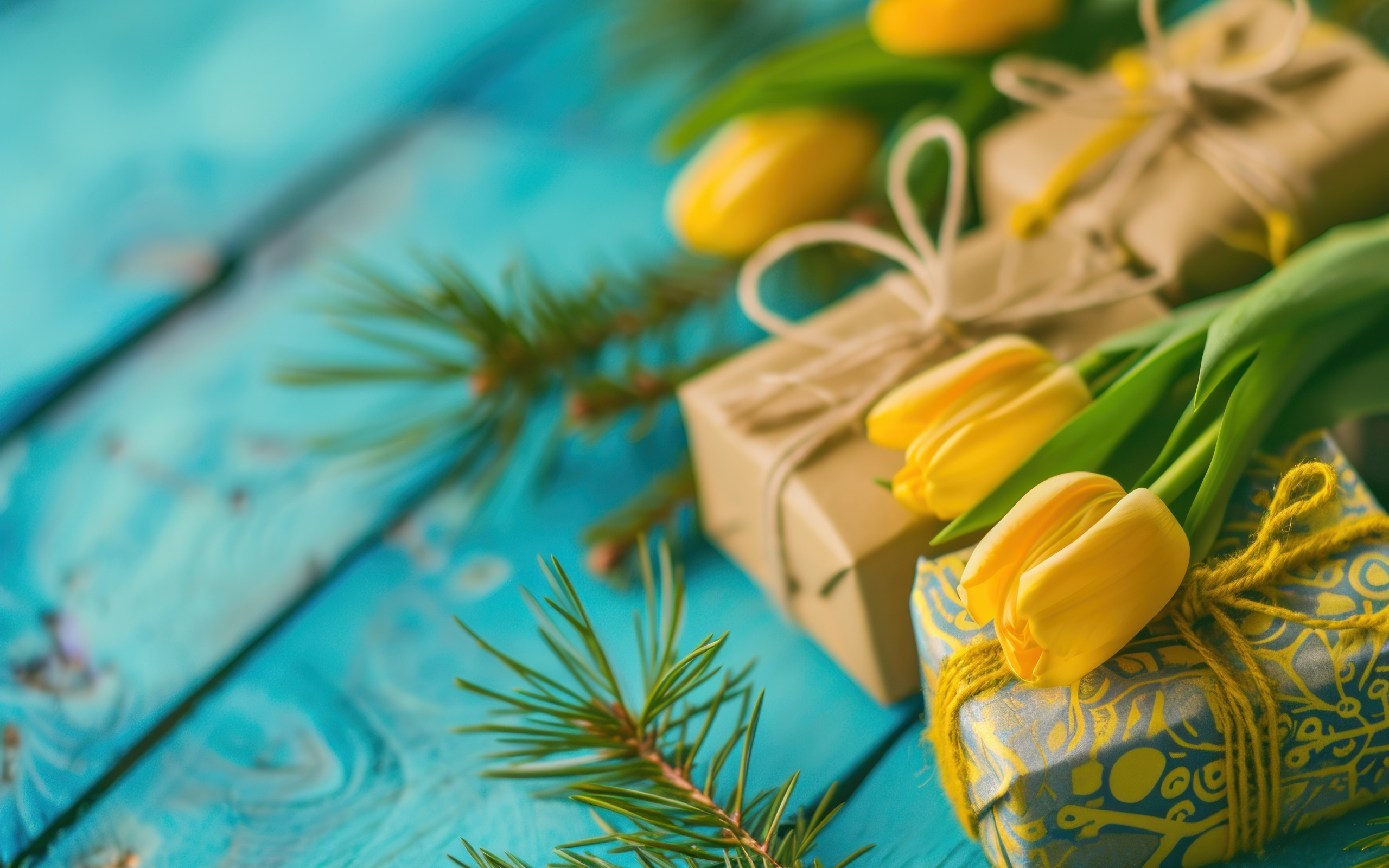 Желтые тюльпаны, еловые ветки и подарки на голубом столе