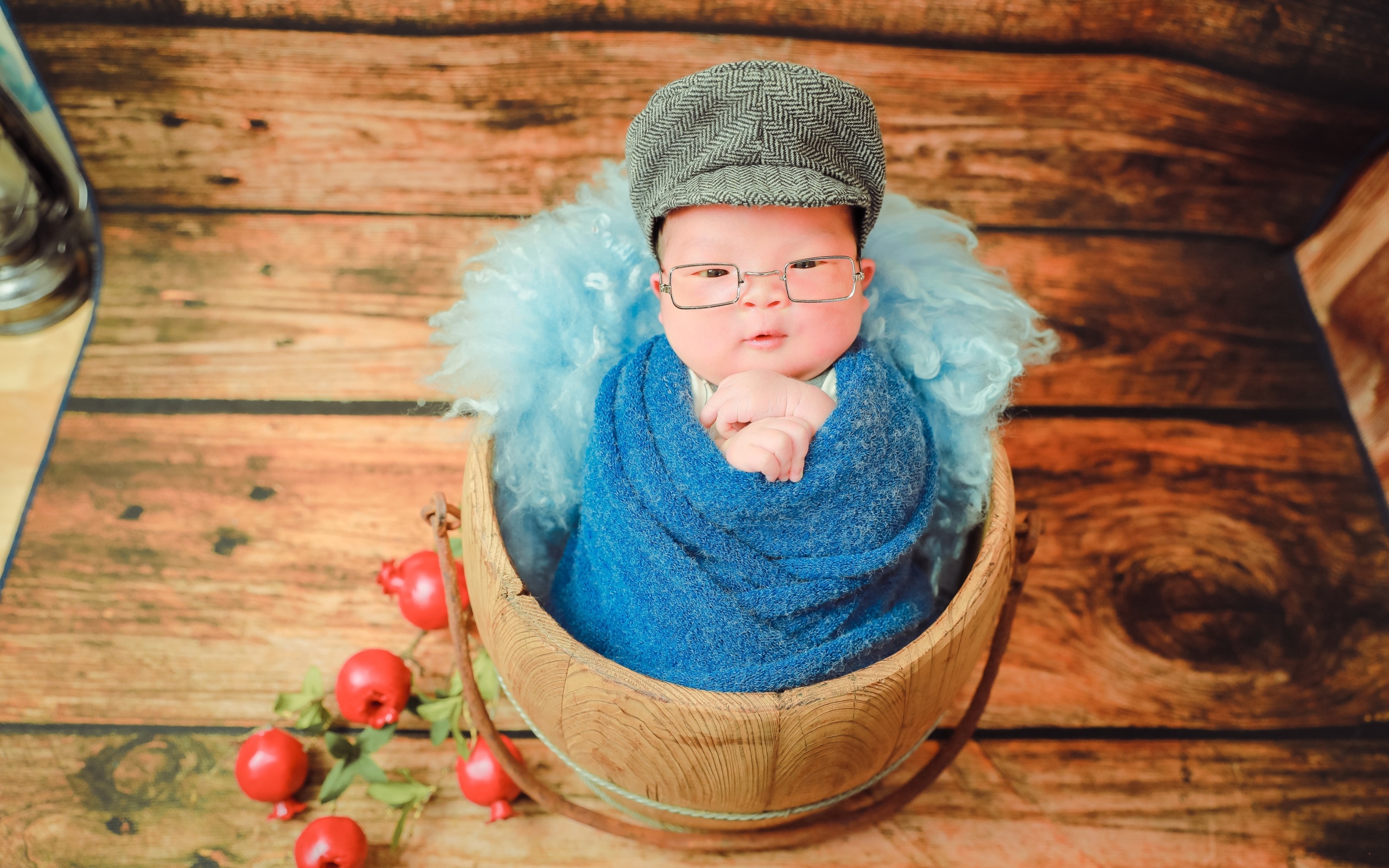 Новорожденный малыш в покрывале с кепкой на голове