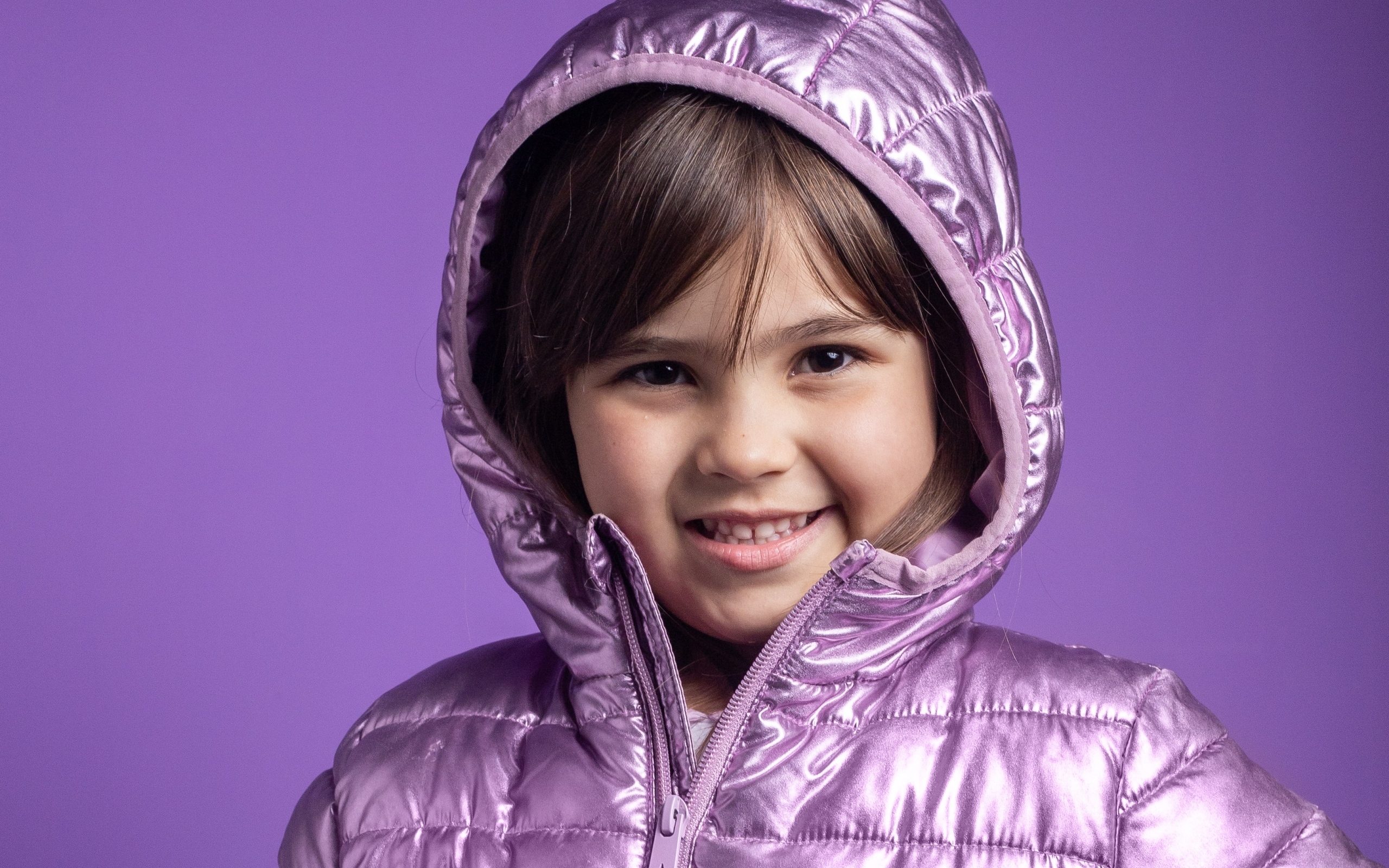Улыбающаяся девочка в сиреневой куртке