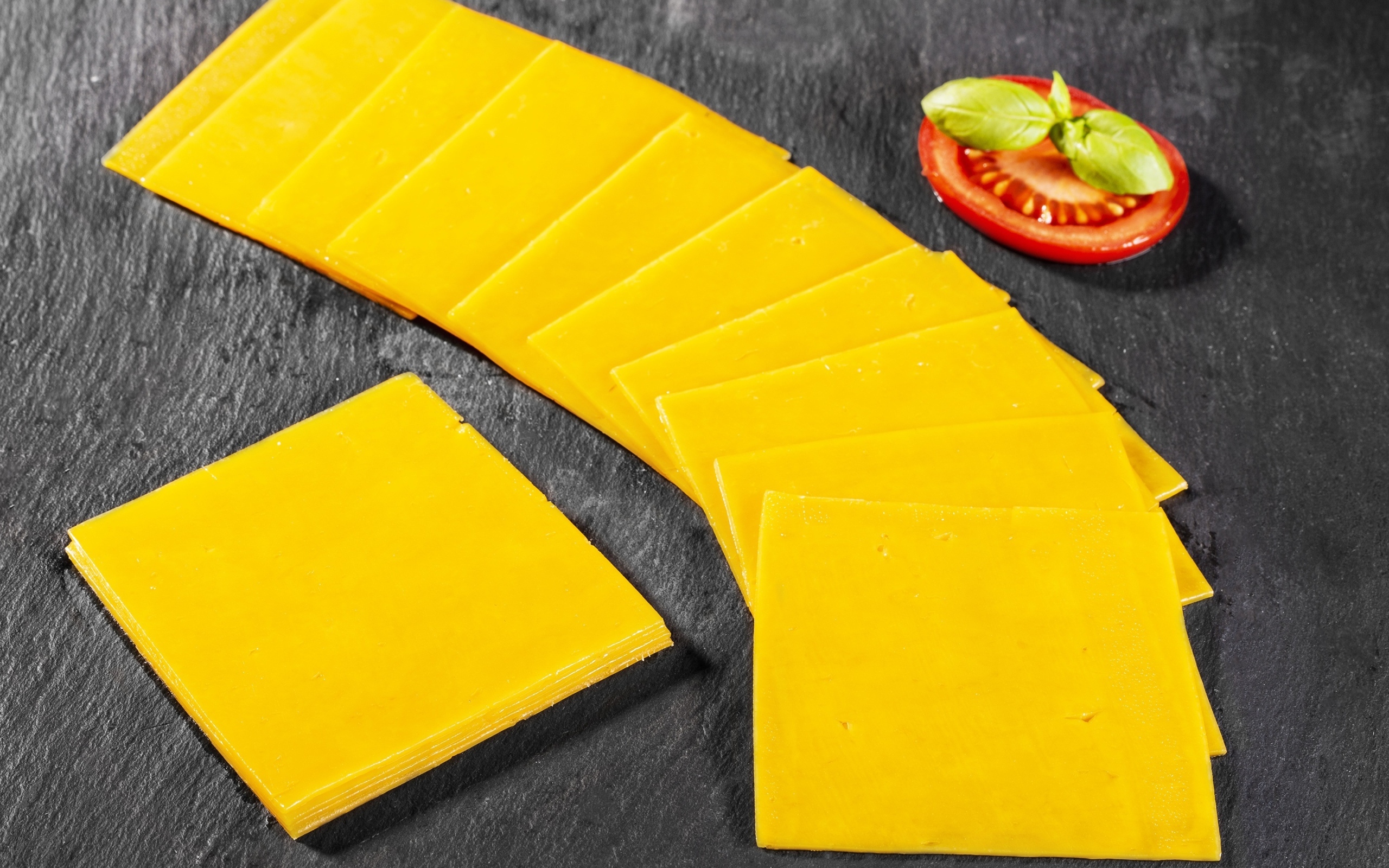 Ломтики сыра с помидором на столе